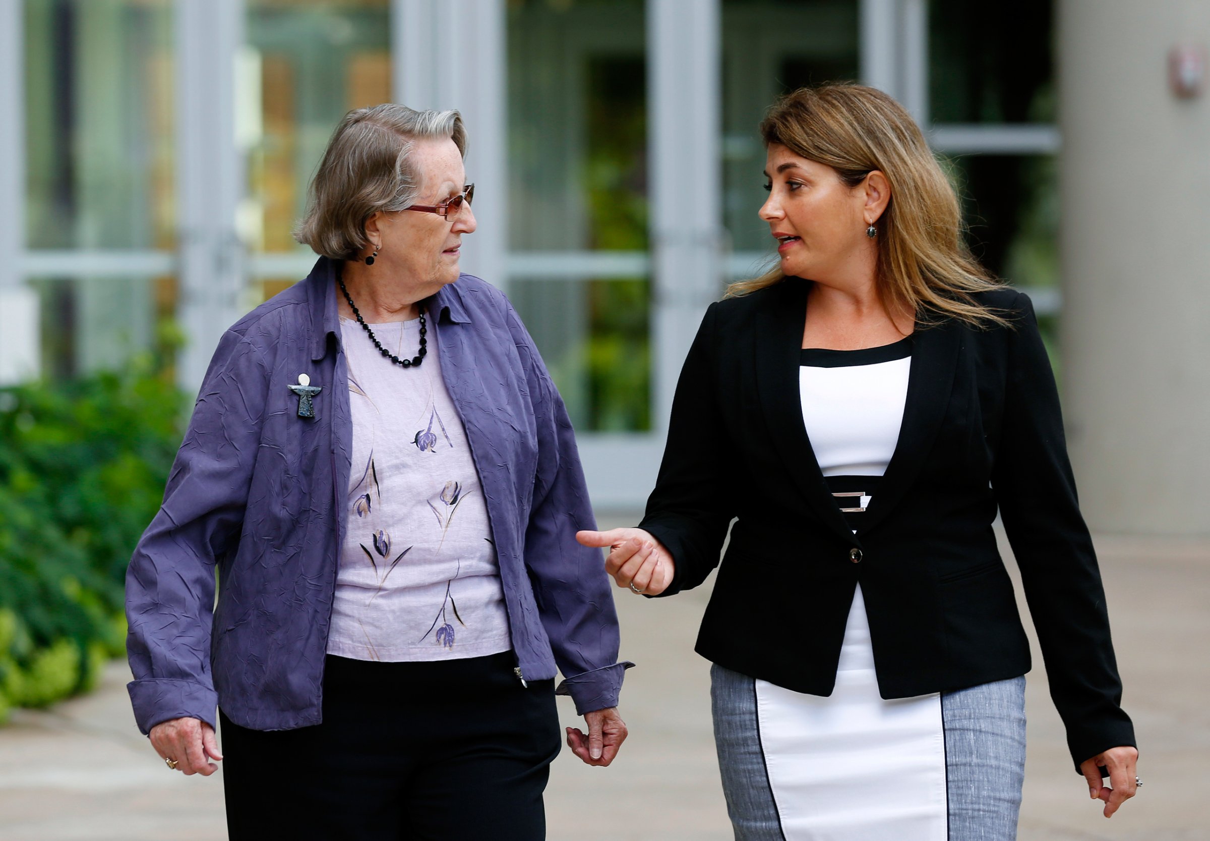 CORRECTS IDENTIFICATION - In this Aug. 11, 2016 photo, Angela McArthur, right, director of the Anatomy Bequest Program at the University of Minnesota Medical School, walks with Jean Larson, widow of a donor in Minneapolis. Once a relatively rare option, body donation has surged at medical schools, including the University of Minnesota. The increase has helped provide cadavers for dissection by first-year medical students, and for research and surgical training. (AP Photo/Andy Clayton-King)