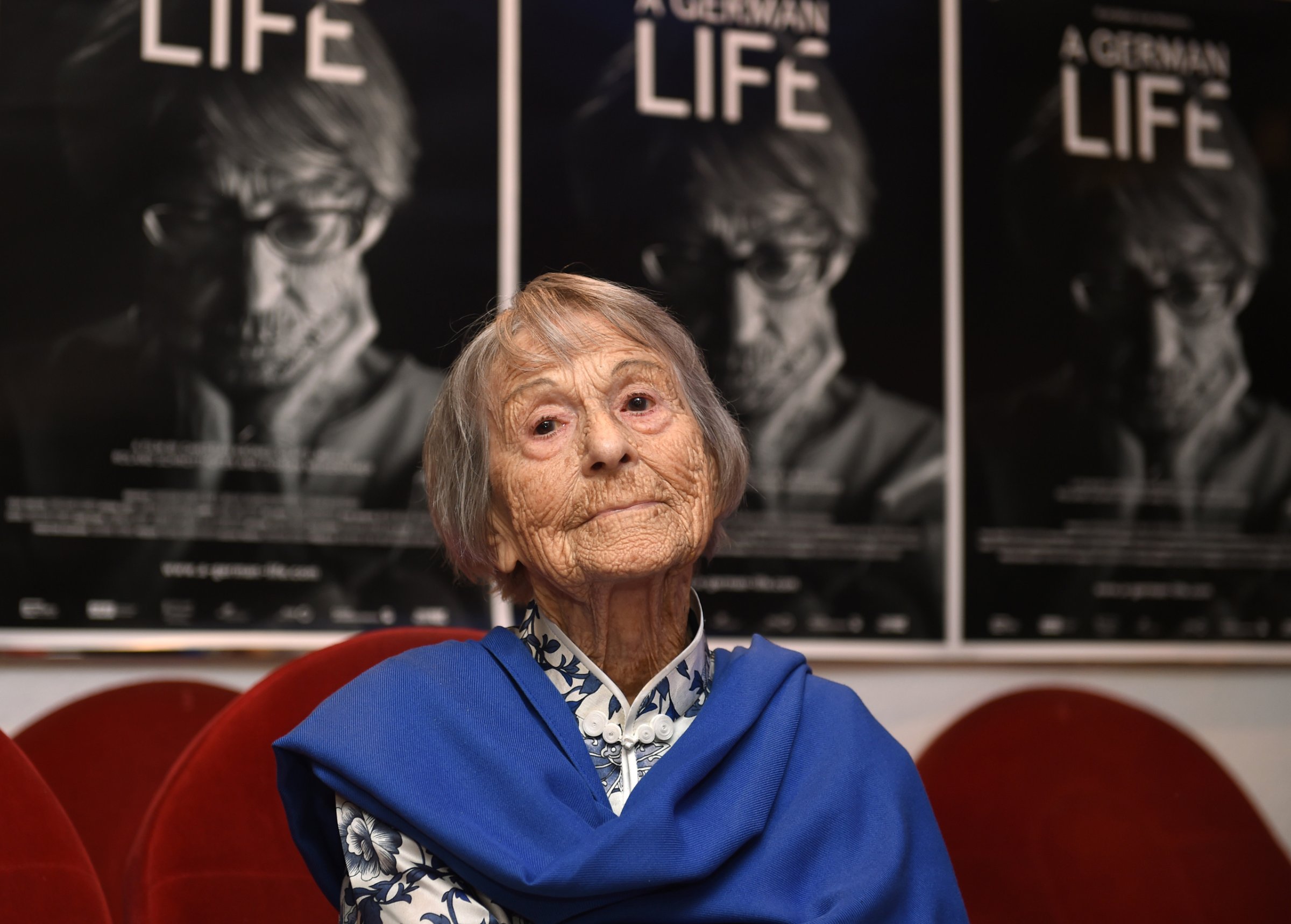 Brunhilde Pomsel, former secretary of Nazi propaganda chief Joseph Goebbels, sits on a cinema chair in front of posters for the movie "A German life" in a cinema in Munich, southern Germany, on June 29, 2016.