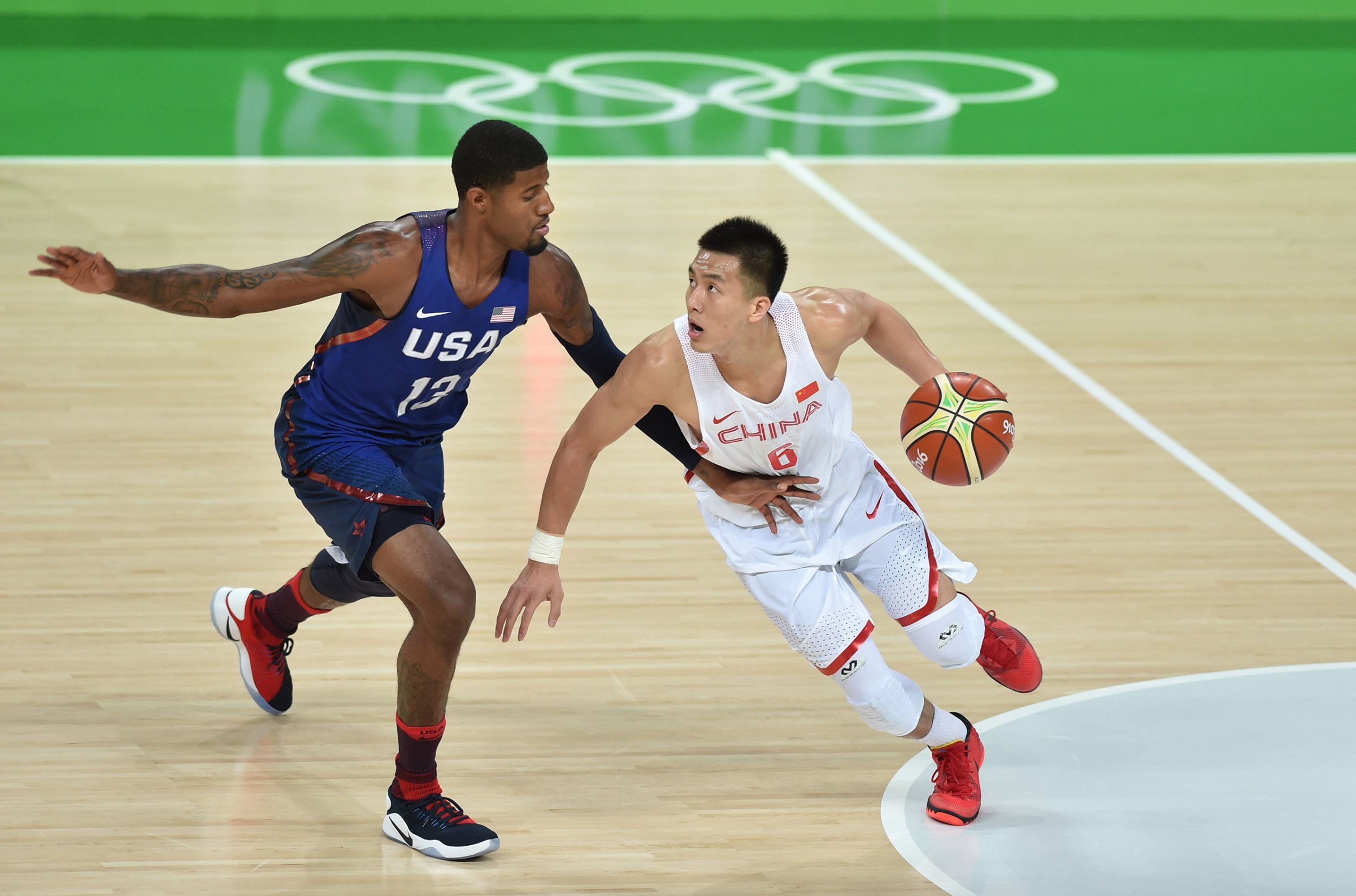 Paul George and Ailun Guo in action during the China vs USA basketball game at the 2016 Rio Olympic Games on Aug. 6, 2016.