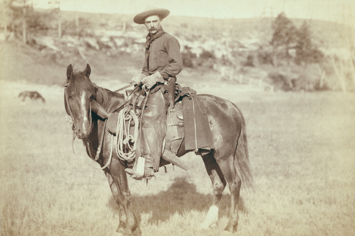 A cowboy on a horse, looking towards the camera, circa 1890 (Buyenlarge / Getty Images)