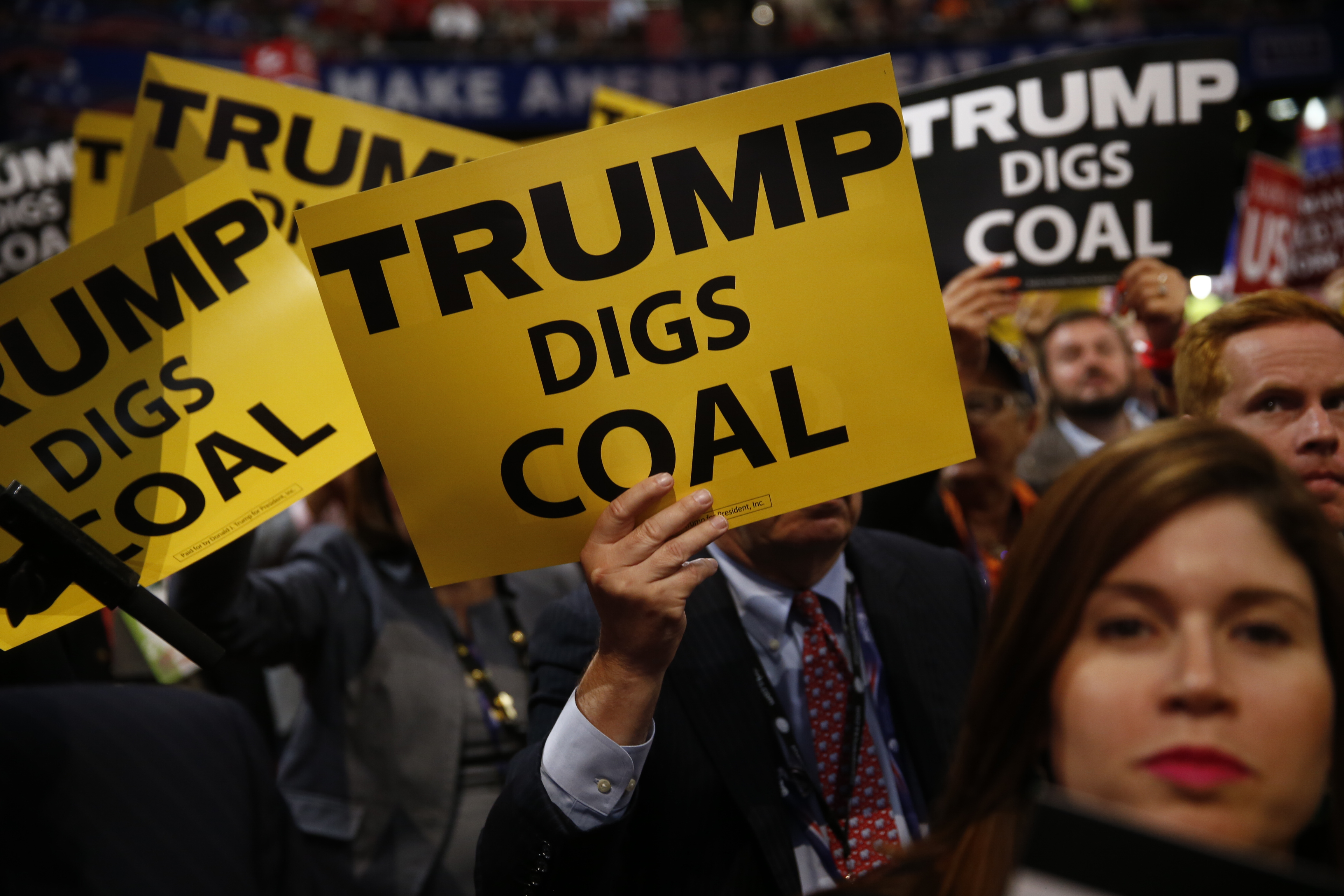 Delegates hold signs reading "Trump Digs Coal" during the Republican National Convention (RNC) in Cleveland, Ohio, U.S., on July 19, 2016. (Bloomberg—Bloomberg via Getty Images)