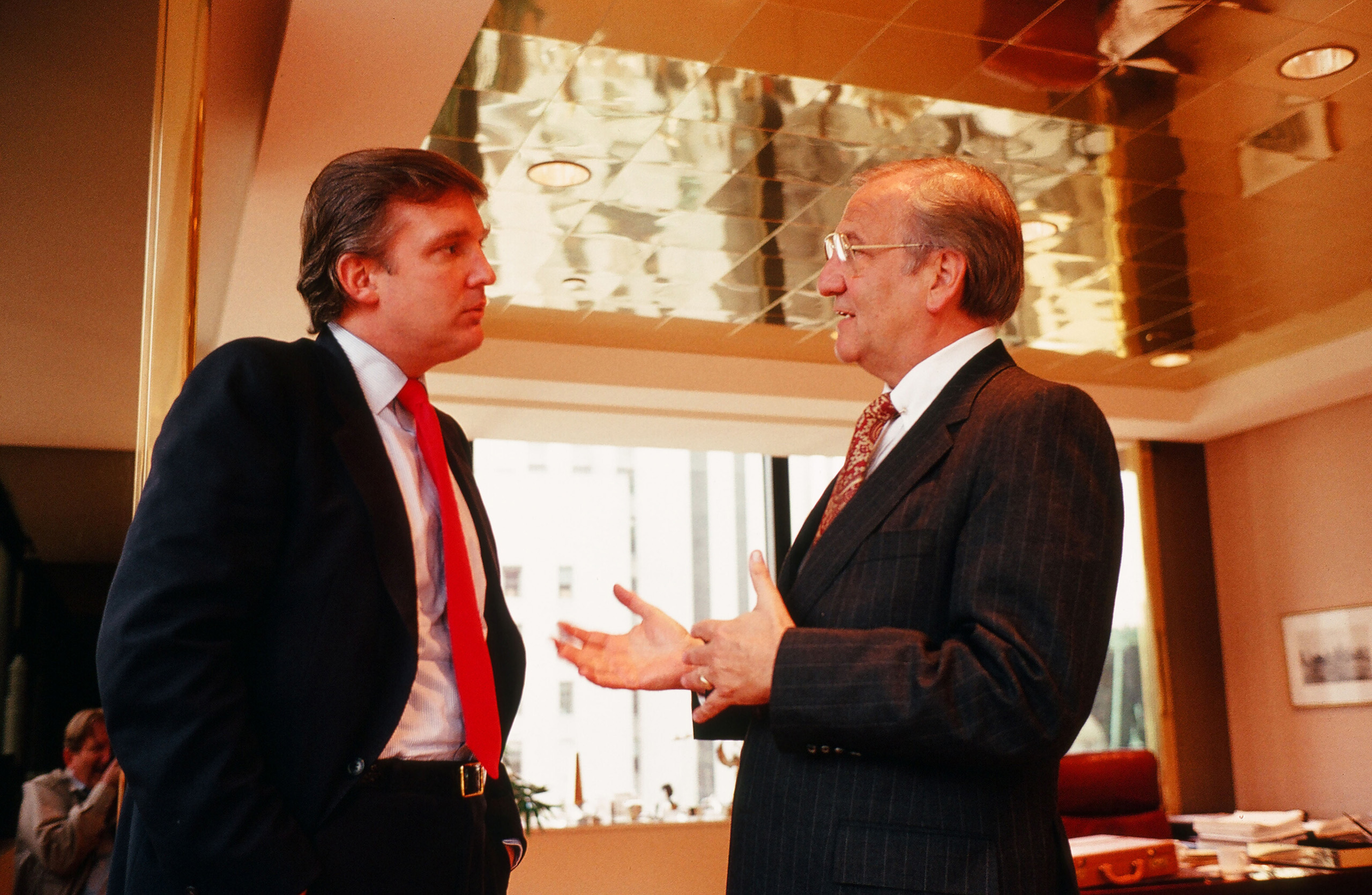American businessman Donald Trump (left) meets with Chrysler CEO Lee Iacocca at Trump's office, in New York City in 1987.