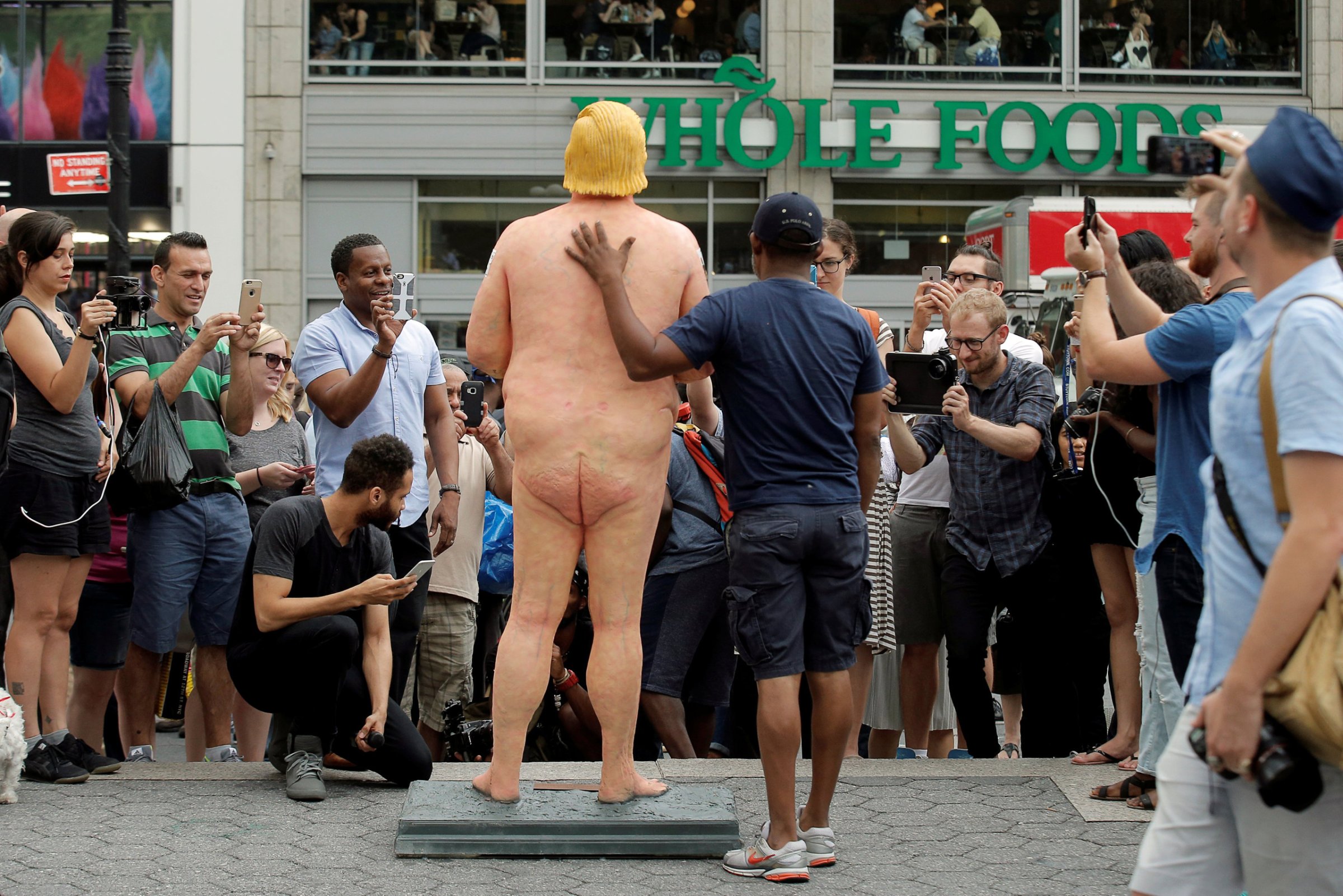People photograph a naked statue of Republican U.S. presidential nominee Donald Trump that was left in Union Square Park in New York City on Aug. 18, 2016.