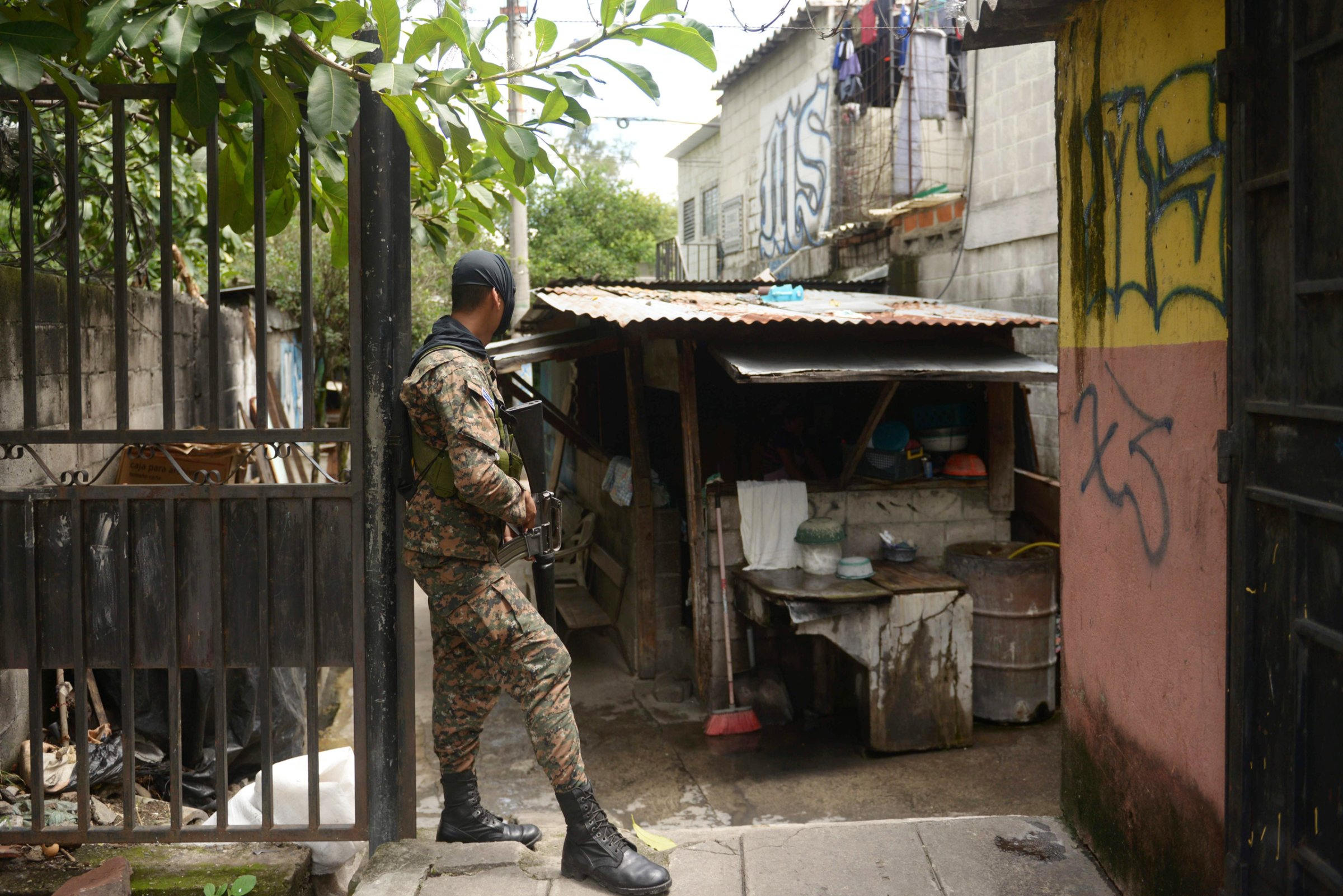 A soldier stands guard in a neighborhood dominated by the Mara Salvatrucha's gang in San Salvador, during an operation to take back gang-controlled neighborhoods, on Aug. 16, 2016.