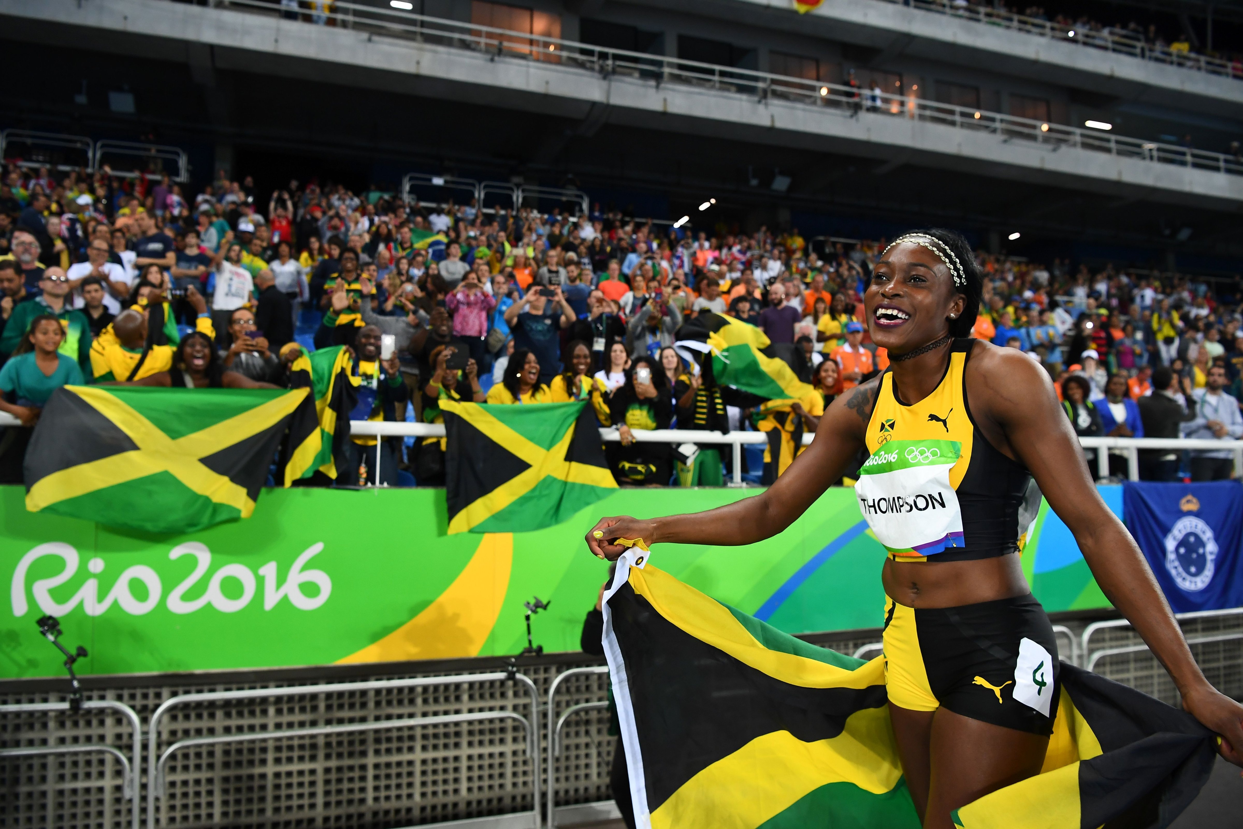 Jamaica's Elaine Thompson celebrates after she won the Women's 100m Final during the athletics event at the Rio 2016 Olympic Games at the Olympic Stadium in Rio de Janeiro on August 13, 2016. (Franck Fife—AFP—Getty Images)