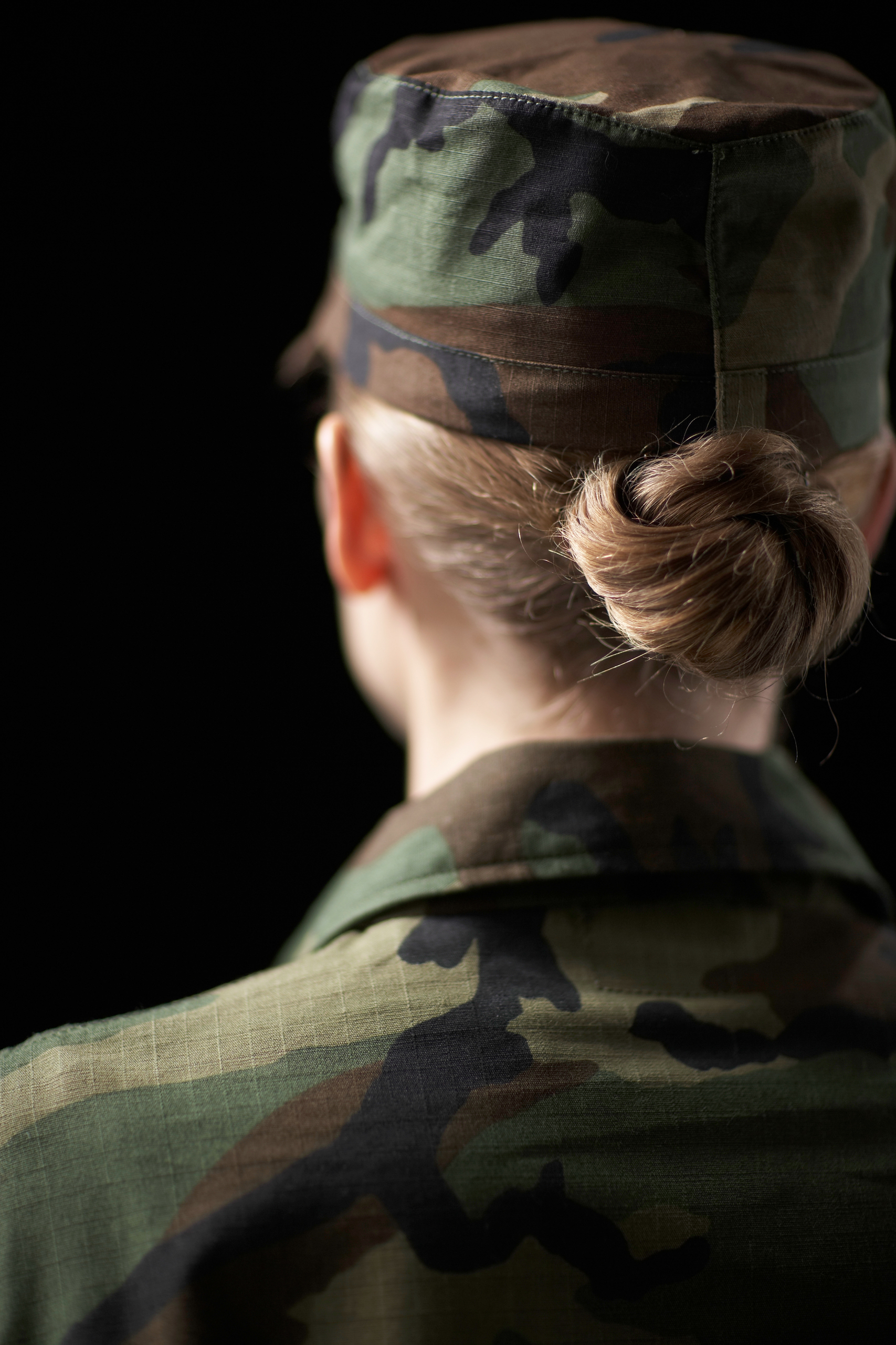 Female soldier wearing army uniform, rear view