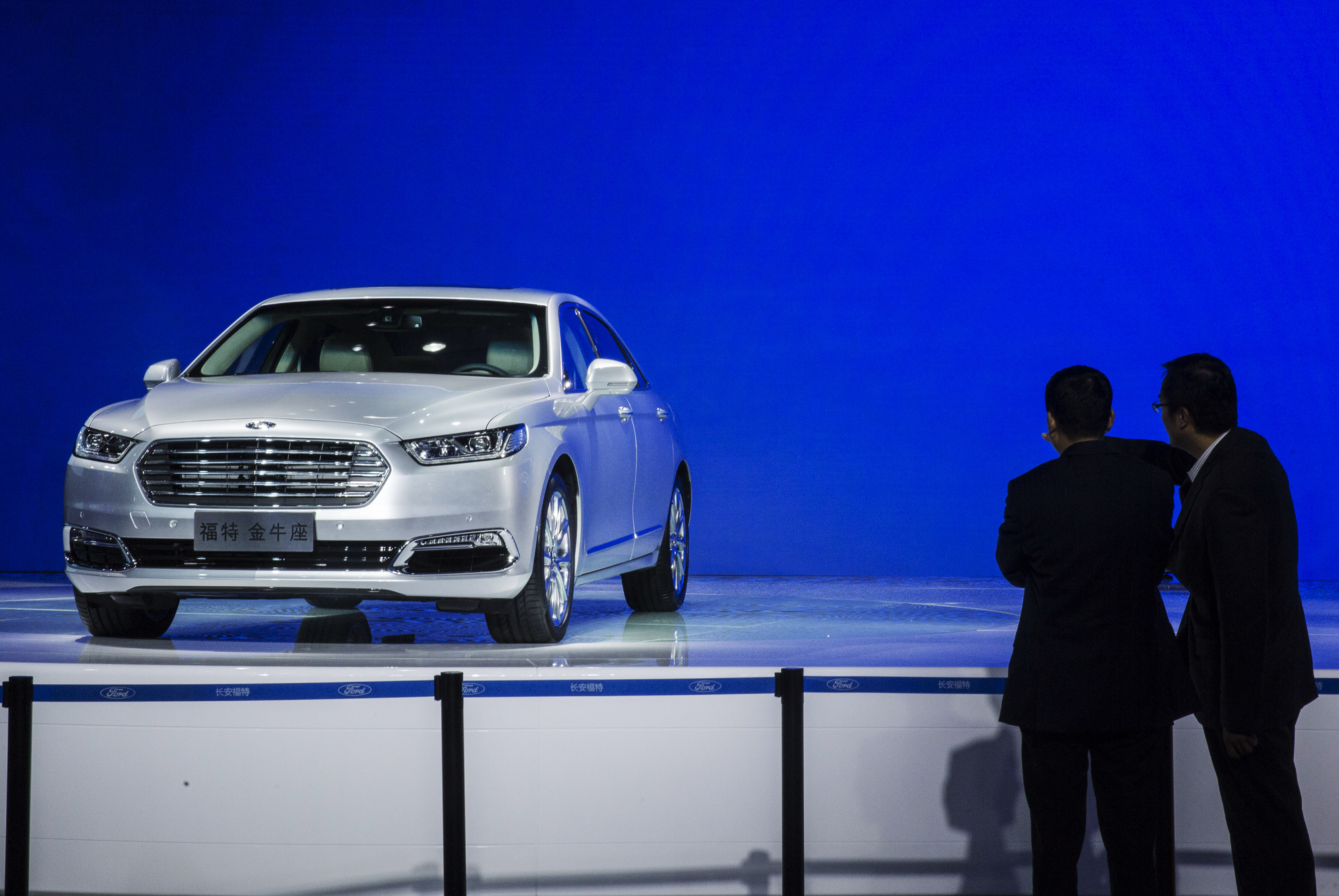 Attendees look at at a Ford Motor Co. Taurus sedan on display during the China (Guangzhou) International Automobile Exhibition in Guangzhou, China, on Friday, Nov. 20, 2015. (Bloomberg—Bloomberg via Getty Images)