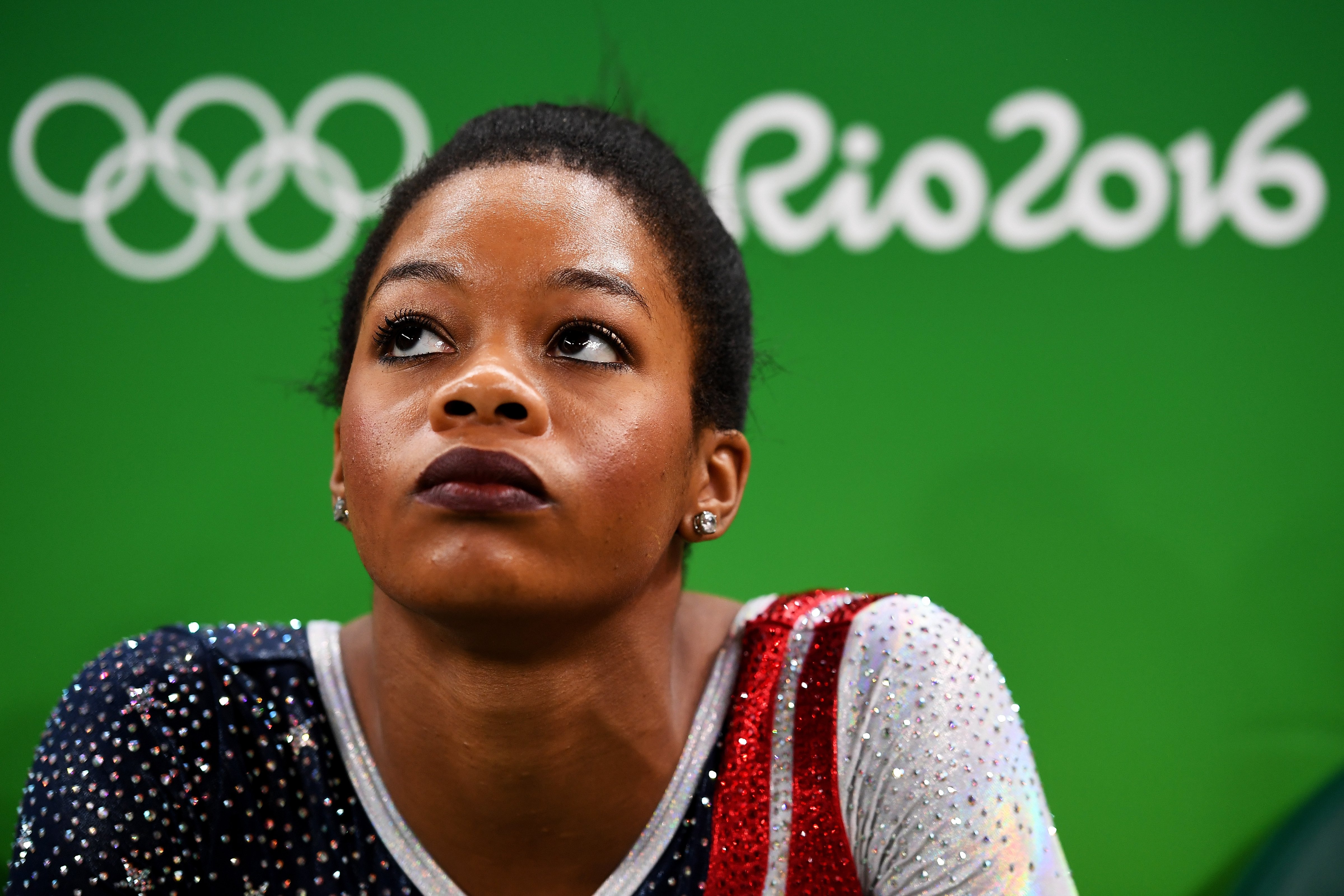 RIO DE JANEIRO, BRAZIL - AUGUST 09: Gabrielle Douglas of the United States looks on during the Artistic Gymnastics Women's Team Final on Day 4 of the Rio 2016 Olympic Games at the Rio Olympic Arena on August 9, 2016 in Rio de Janeiro, Brazil.  (Photo by Laurence Griffiths/Getty Images) (Laurence Griffiths/;Getty Images)