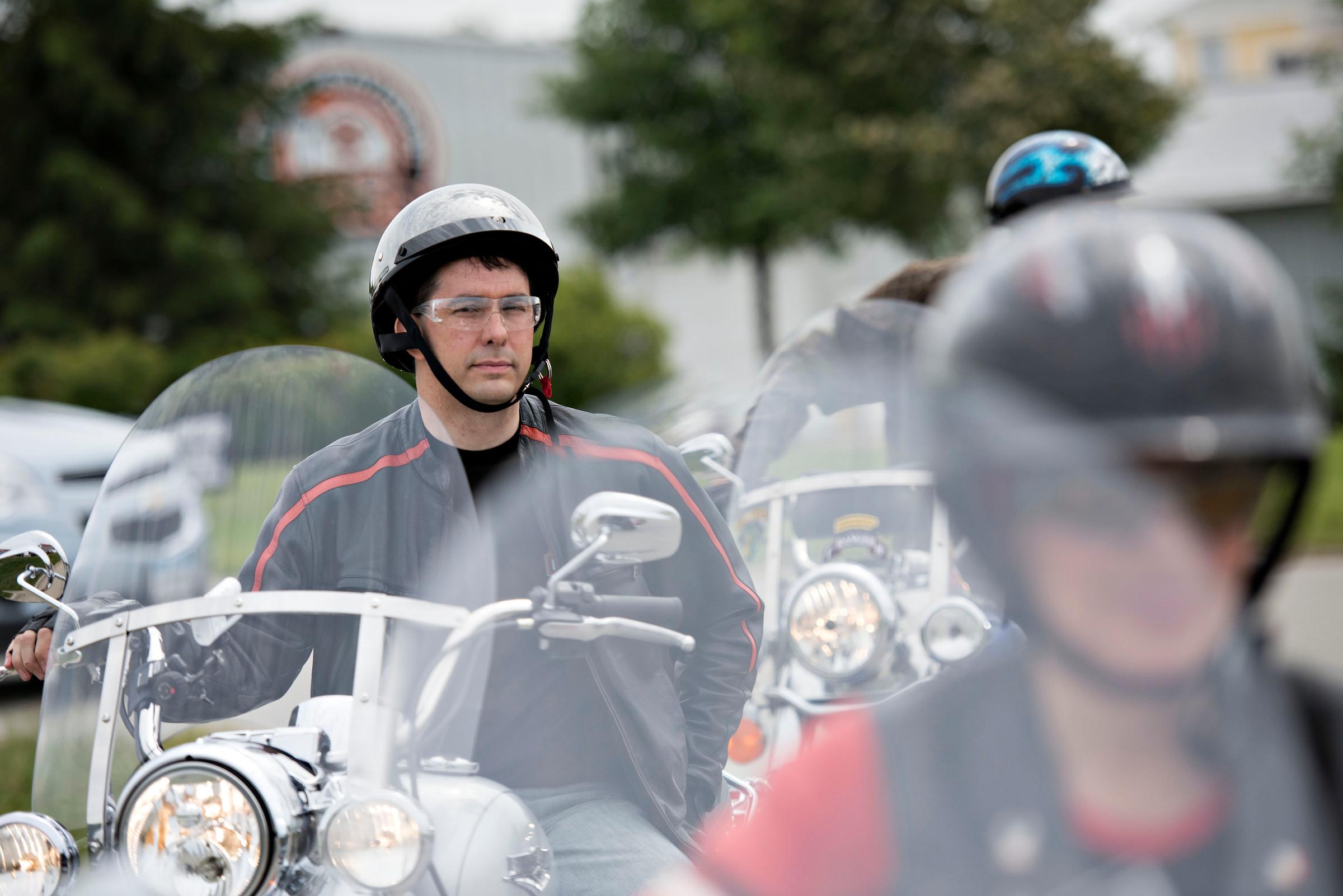 Scott Walker, governor of Wisconsin, sits on a Harley Davidson motorcycle as he awaits the start of a group ride at Big Barn Harley Davidson in Des Moines, Iowa, U.S., on Saturday, June 6, 2015.