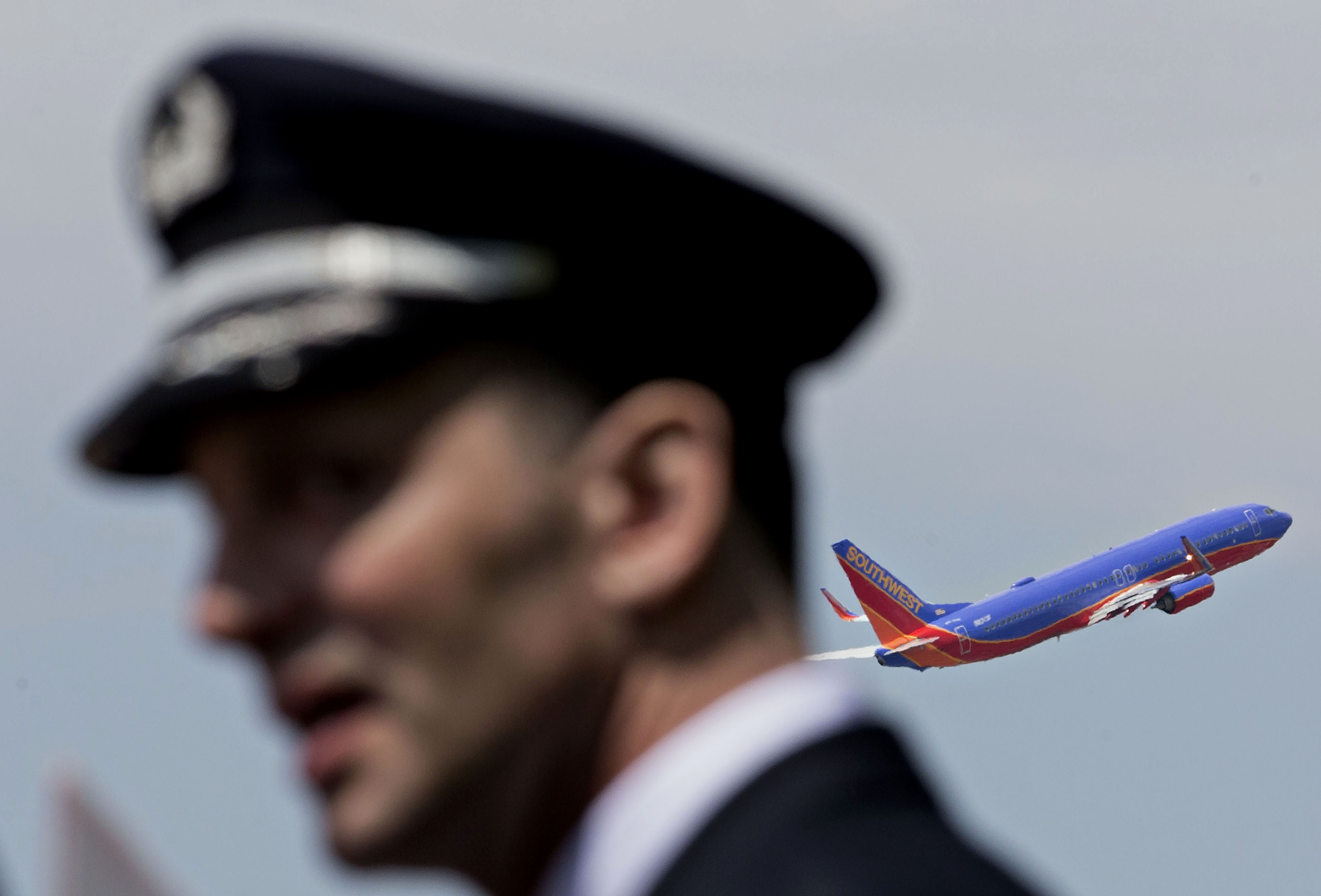 A Southwest Airlines Co. plane takes off a pilot from the Southwest Airlines Pilots' Association (SWAPA) demonstrates outside Chicago Midway International Airport (MDW) in Chicago, Illinois, U.S., on Wednesday, May 18, 2016. (Bloomberg&mdash;Bloomberg via Getty Images)