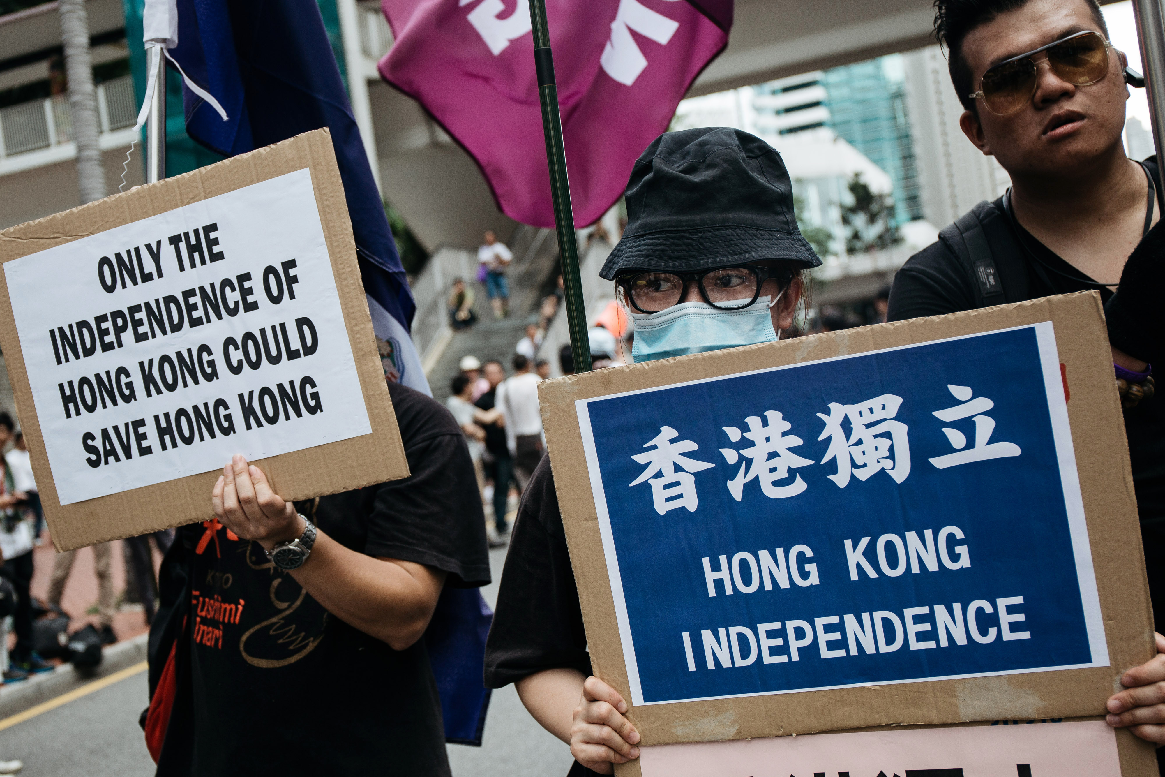 Protesters hold placards calling for Hong Kong's independence as they march on the street during a rally on July 1, 2016, in Hong Kong (Bloomberg/Getty Images)