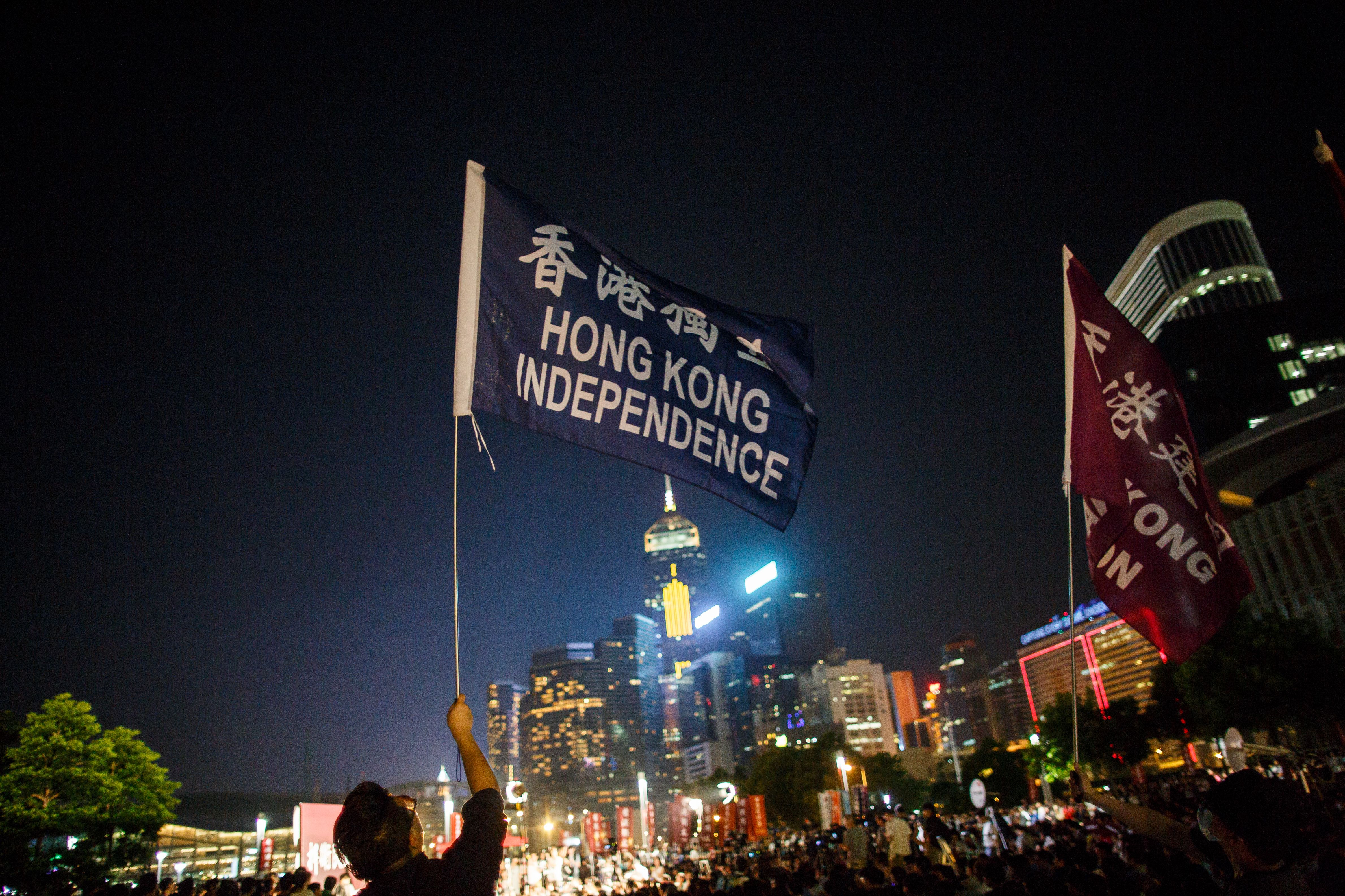 A protester holds a flag that reads "Hong Kong Independence" near the government's headquarters in Hong Kong on Aug. 5, 2016, during the city's first pro-independence rally (Anthony Wallace—AFP/Getty Images)