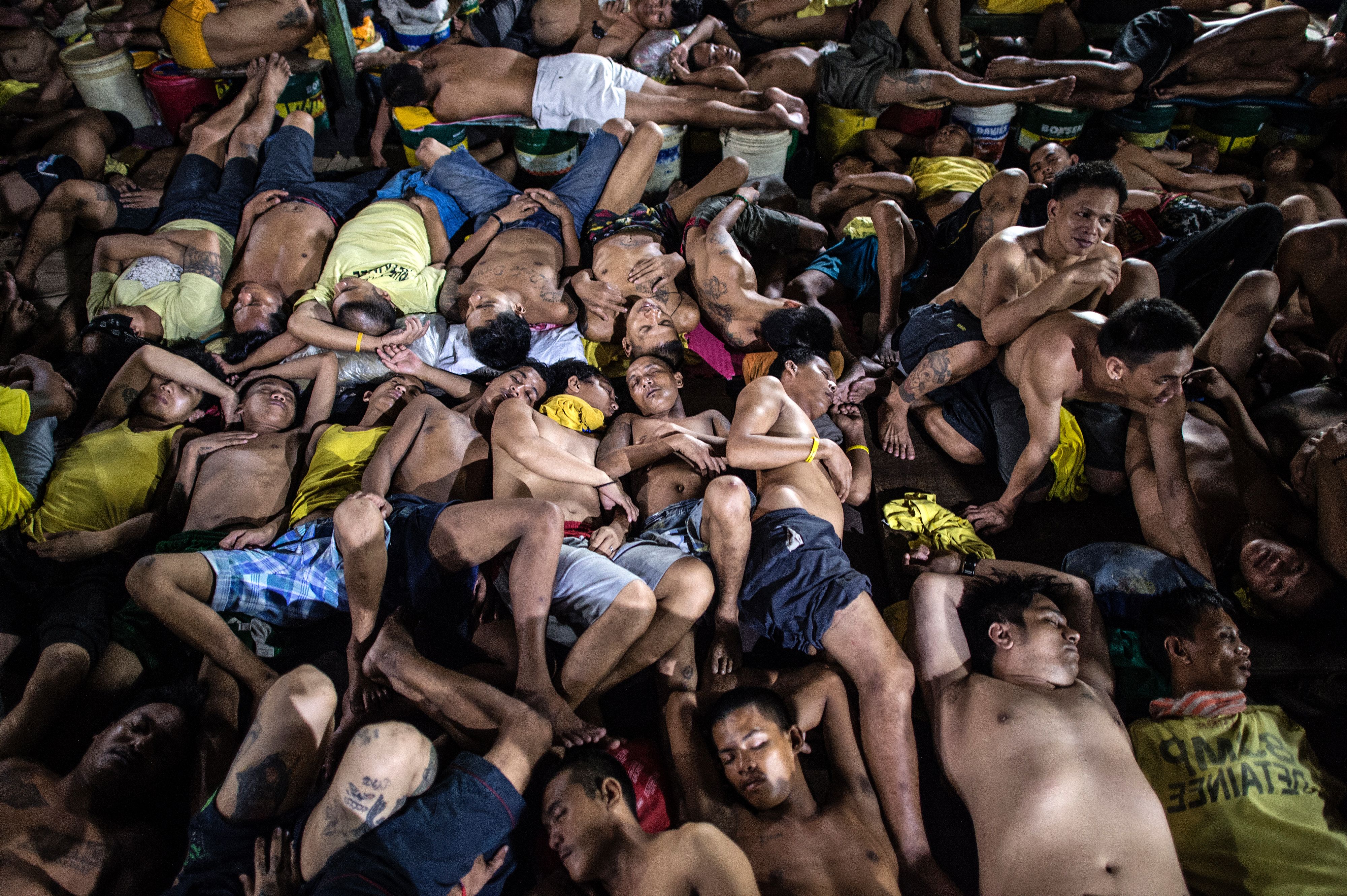 This picture taken on July 21, 2016, shows inmates sleeping inside the Quezon City jail in Manila. Philippine officials said on Aug. 9, 2016, the government would build new jails to address severe congestion made worse by President Rodrigo Duterte's drug war, describing conditions as 