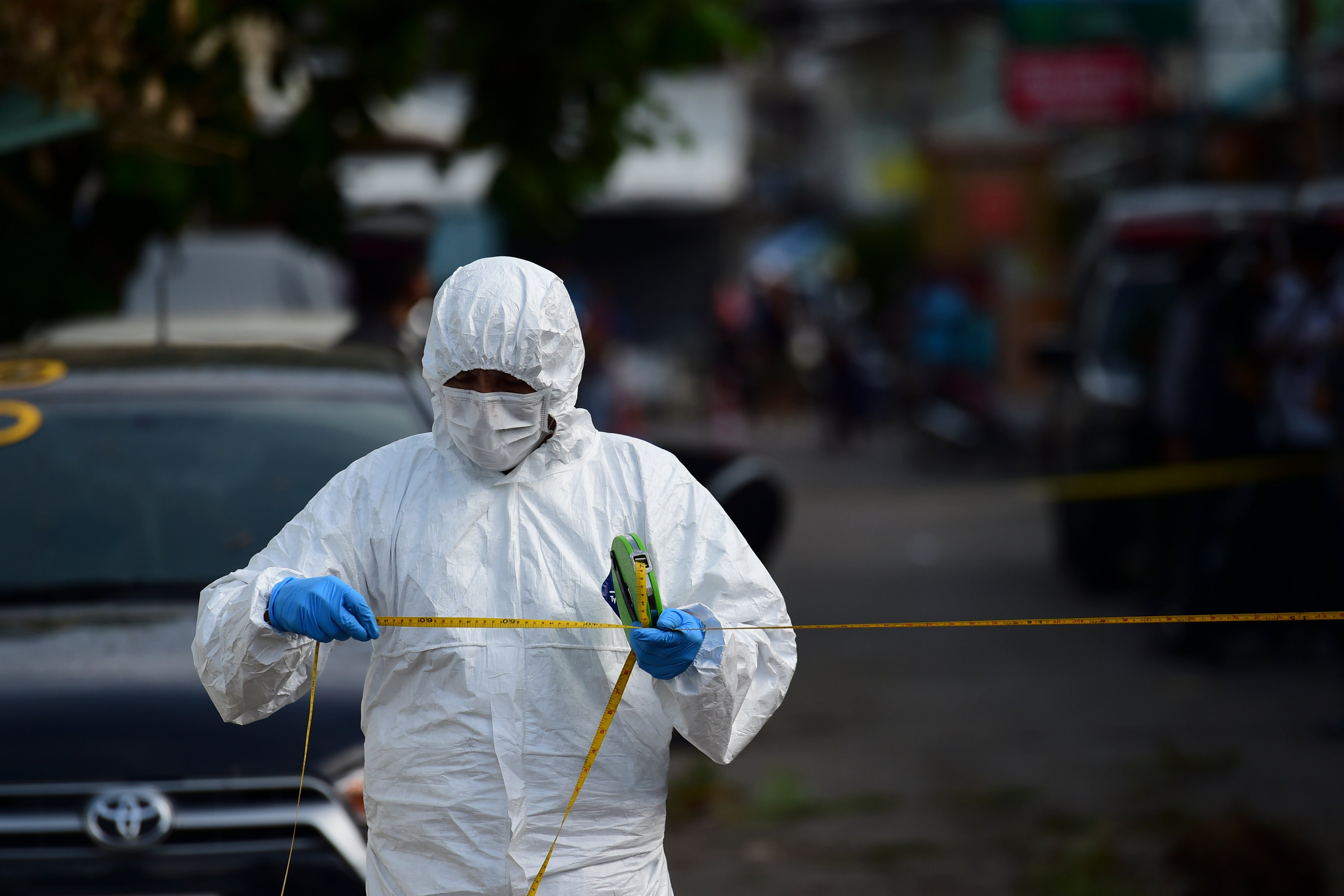 An investigation official collects evidence from the crime scene after a small bomb exploded in Hua Hin, Thailand, on Aug. 12, 2016 (Munir Uz Zaman—AFP/Getty Images)