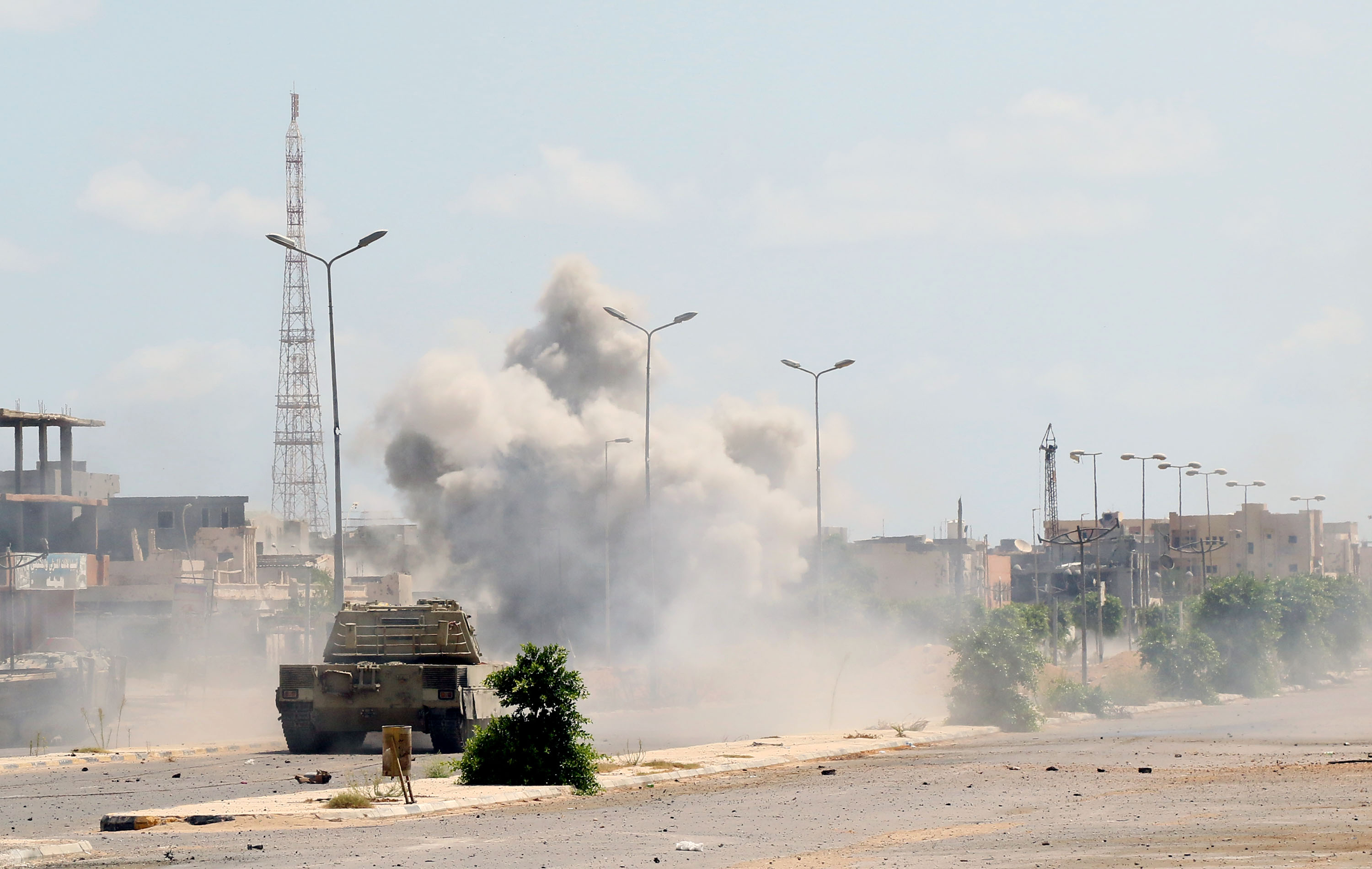 Forces loyal to Libya's UN-backed Government of National Accord (GNA) drive their military vehicle in al-Zaafaran neighbourhood as they fight Islamic State group (IS) jihadists holed up in residential district two on August 14, 2016 in Sirte, east of the capital Tripoli. (MAHMUD TURKIA—AFP/Getty Images)