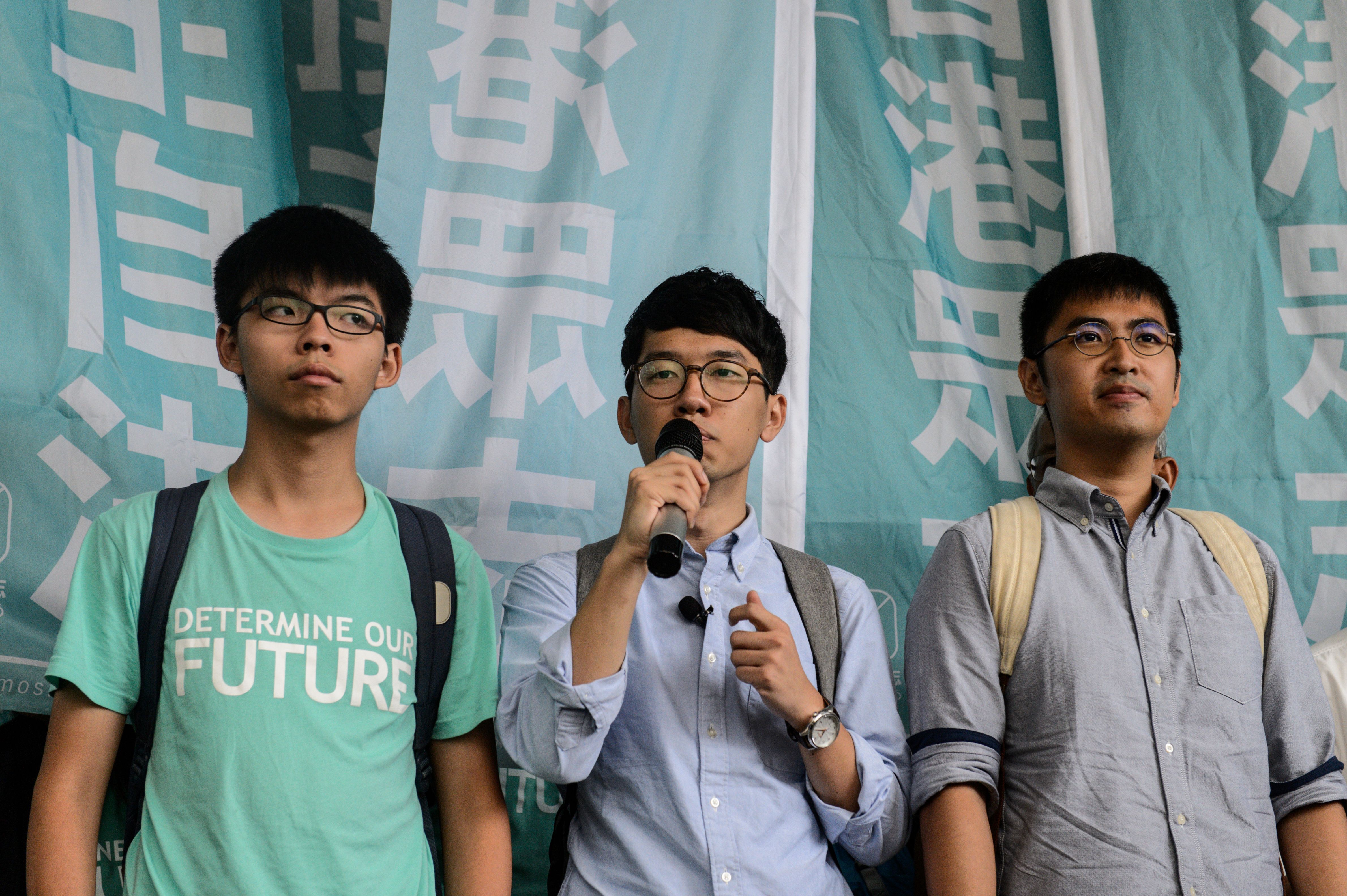 Leaders of Hong Kong's Umbrella Revolution, left to right, Joshua Wong, 19; Nathan Law, 23; and Alex Chow, 25, speak to the press following their sentencing at the Eastern Court in Hong Kong on Aug. 15, 2016 (Anthony Wallace—AFP/Getty Images)