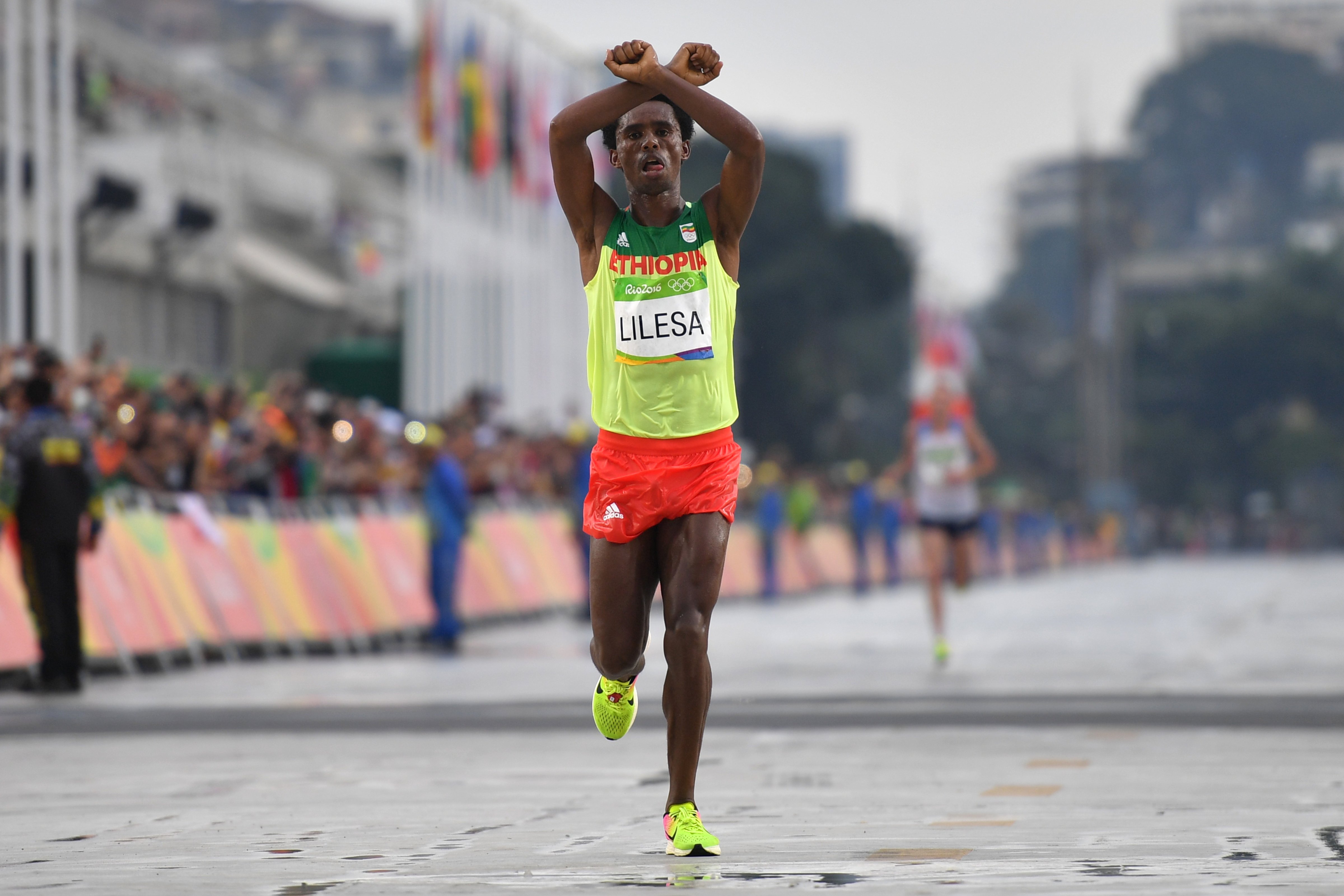Ethiopia's Feyisa Lilesa crosses the finish line of the men's marathon athletics event at the Olympic Games in Rio de Janeiro on Aug. 21, 2016 (Olivier Morin—AFP/Getty Images)