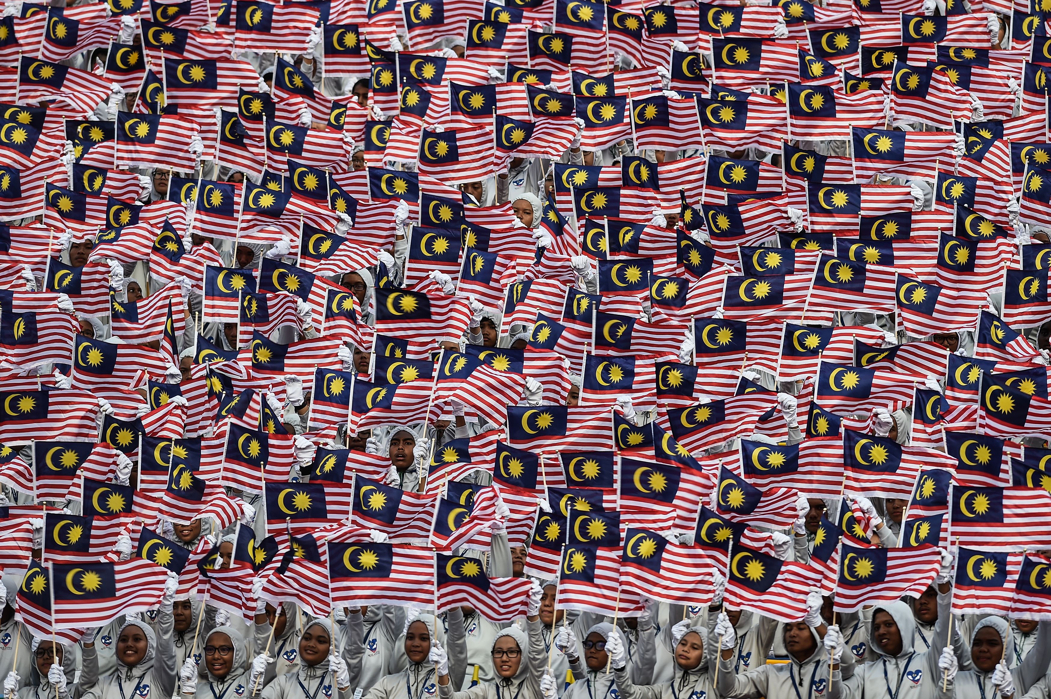 Malaysian schoolchildren wave national flags during the 59th National Day celebrations at Independence Square in Kuala Lumpur on August 31, 2016. (Mohd Rasfan—AFP/Getty Images)