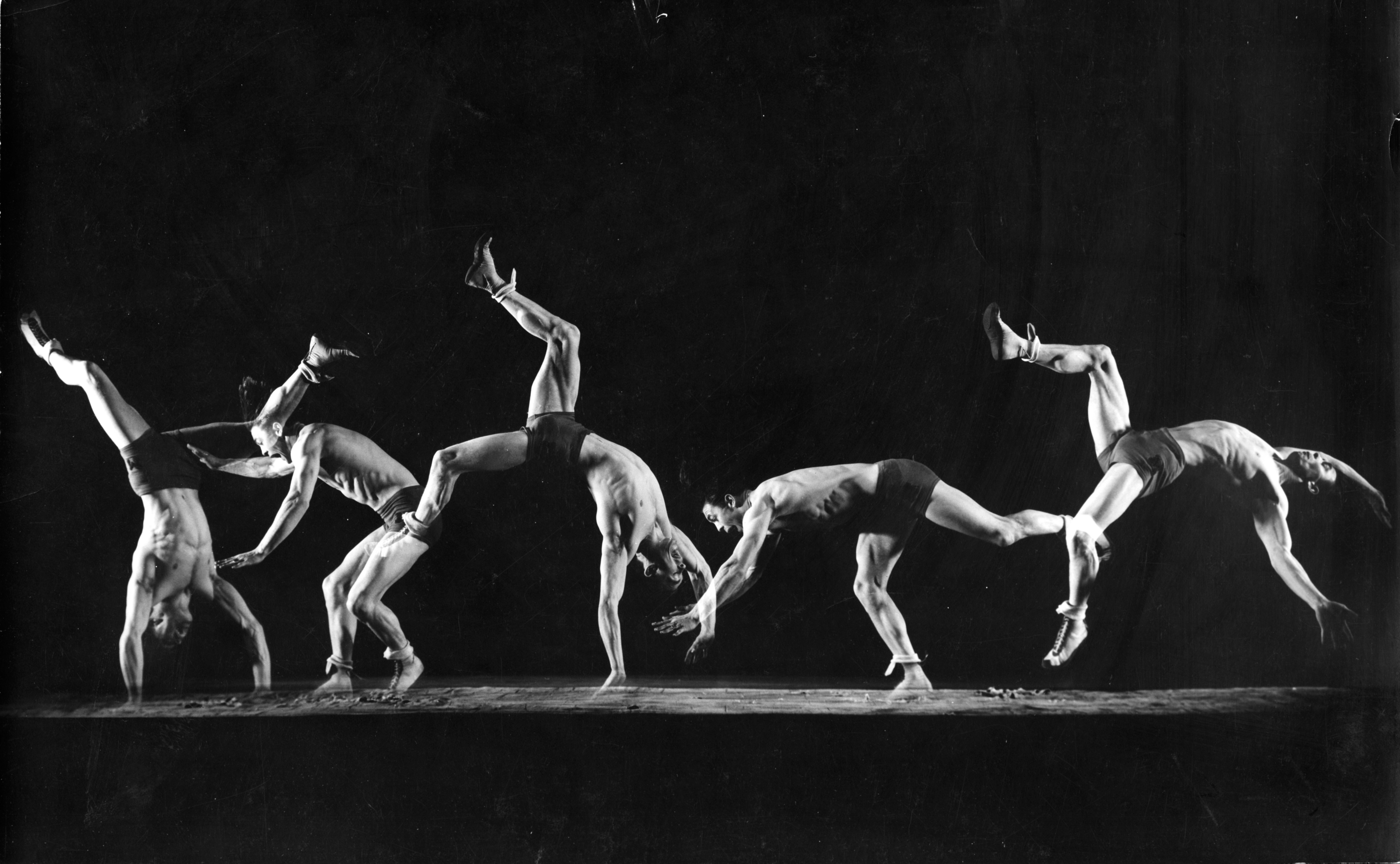 A stroboscopic multiple exposure image of intercollegiate champion gymnast Newt Loken doing cartwheels from left to right in 1942.