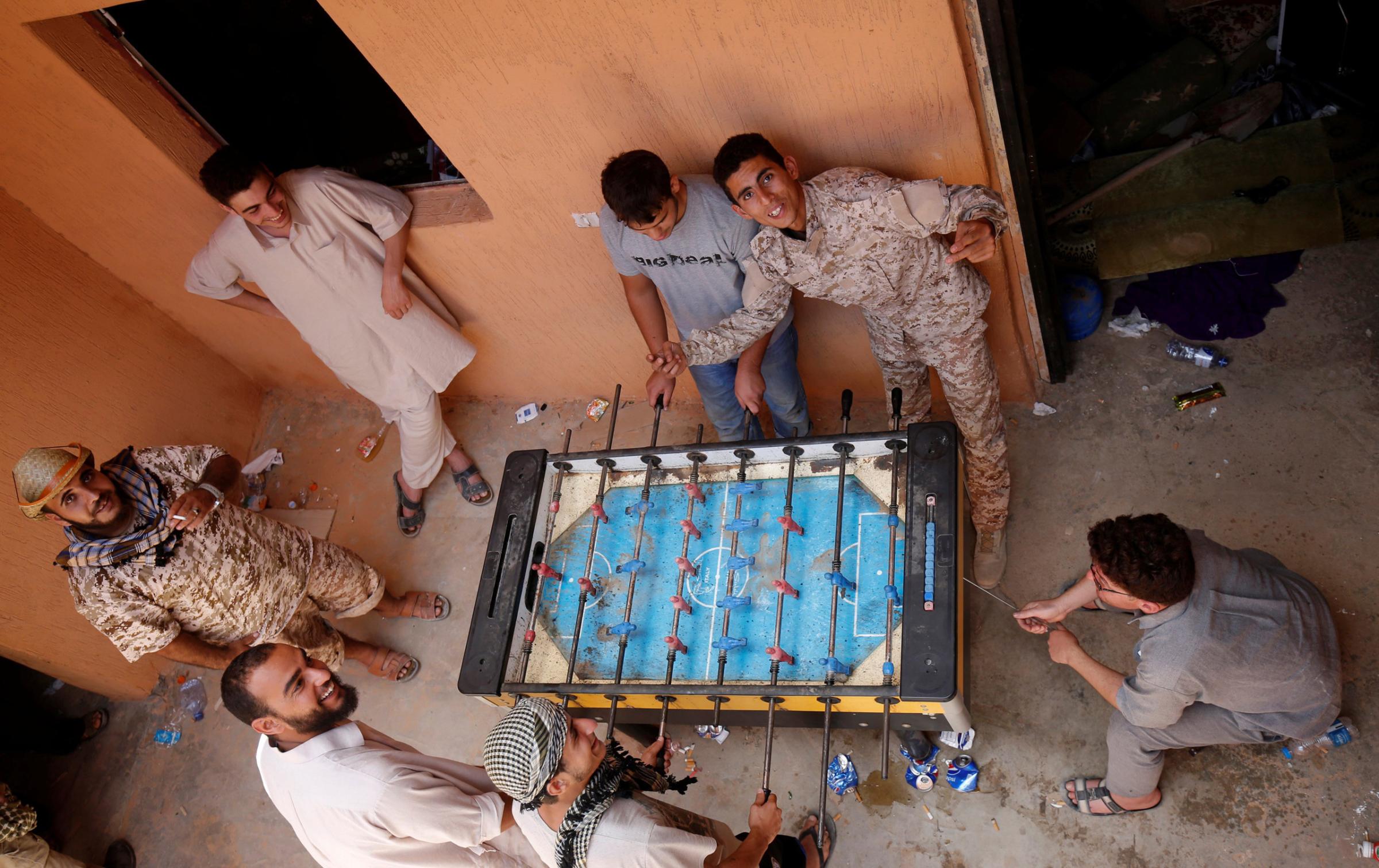 Libyan forces play table football at the frontline in the west part of Sirt, Libya, on July 19, 2016.