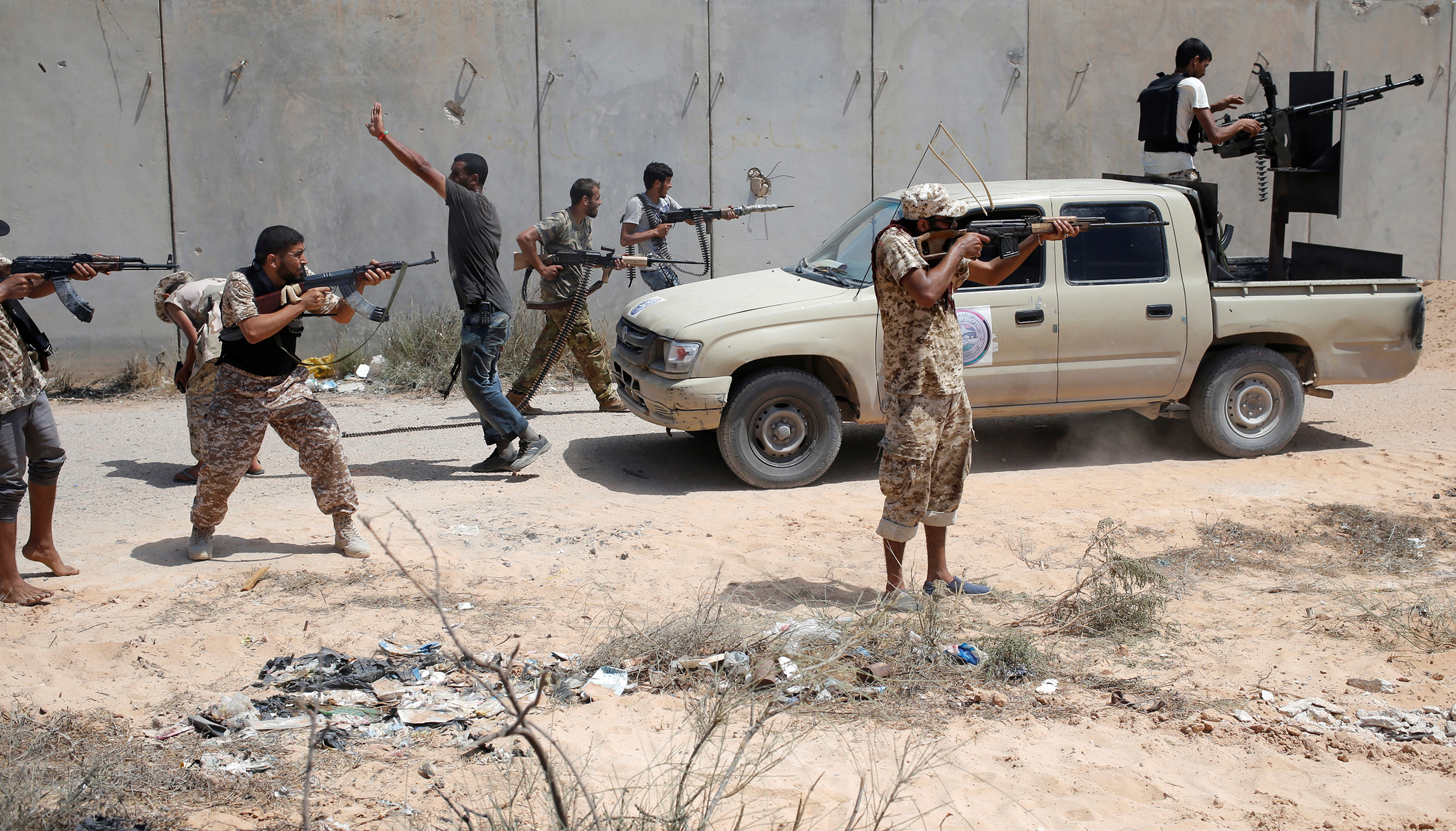 Fighters of the Libyan forces allied with the U.N.-backed unity government fire weapons at ISIS fighters during a battle in Sirt, Libya, on July 31, 2016.