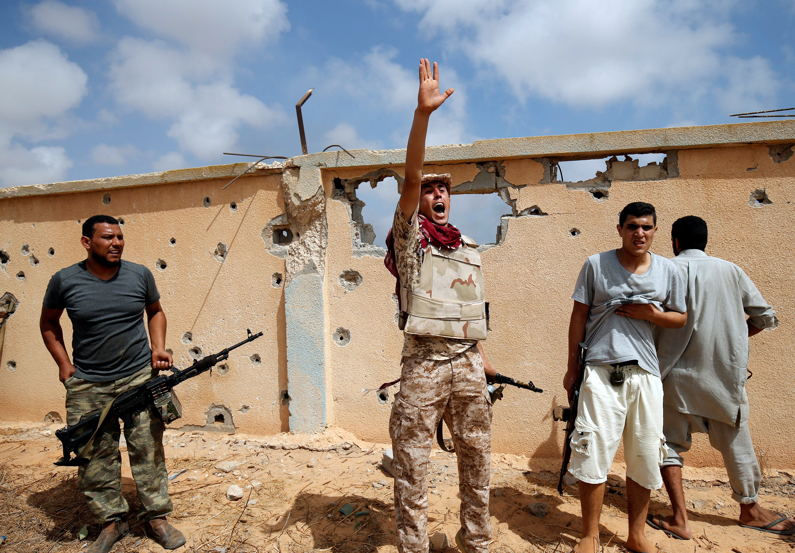 A member of Libyan forces allied with the U.N.-backed unity government gestures during a battle against ISIS in Sirt, Libya, on July 15, 2016.