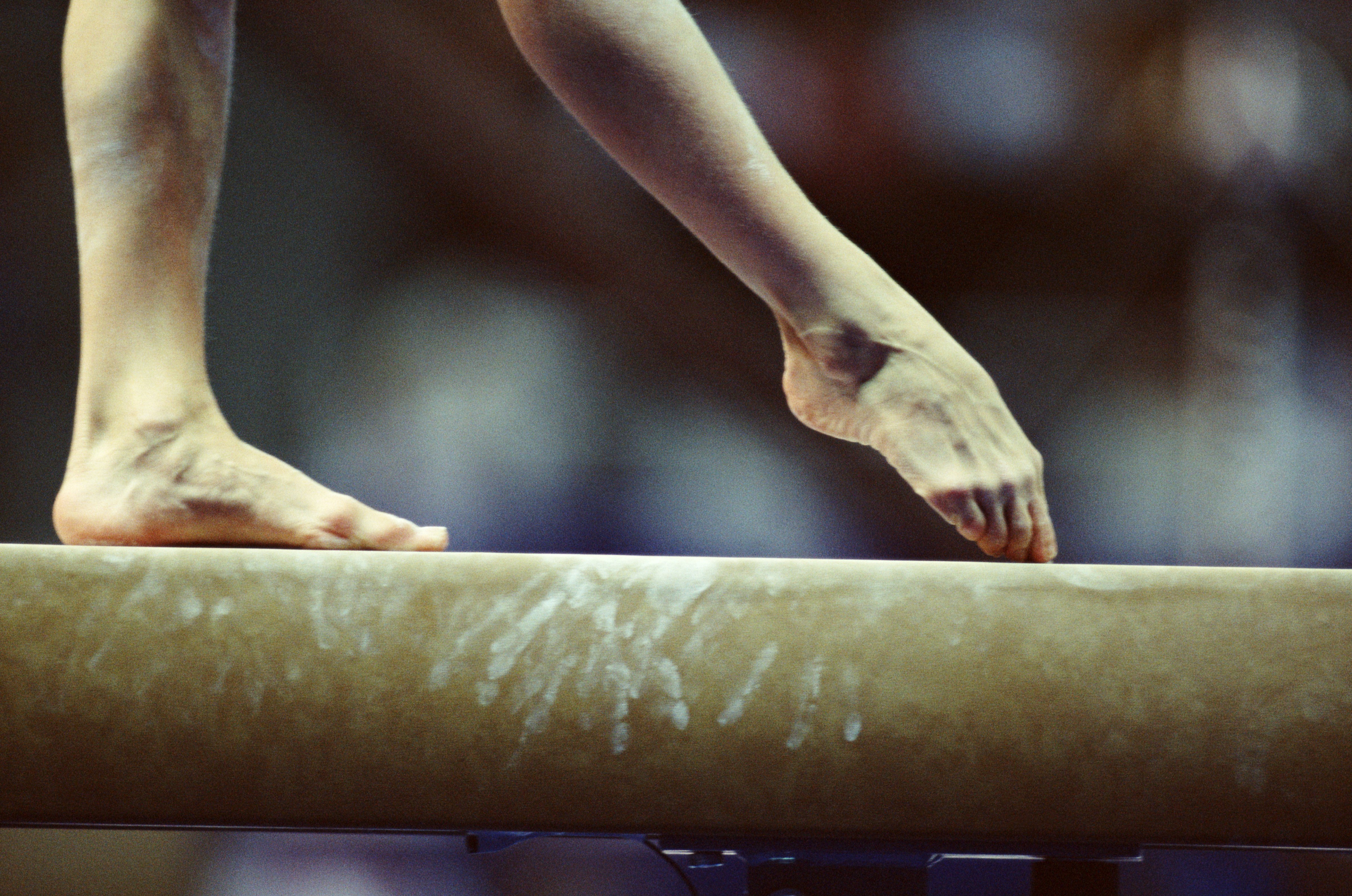 Gymnast on beam, close-up of feet