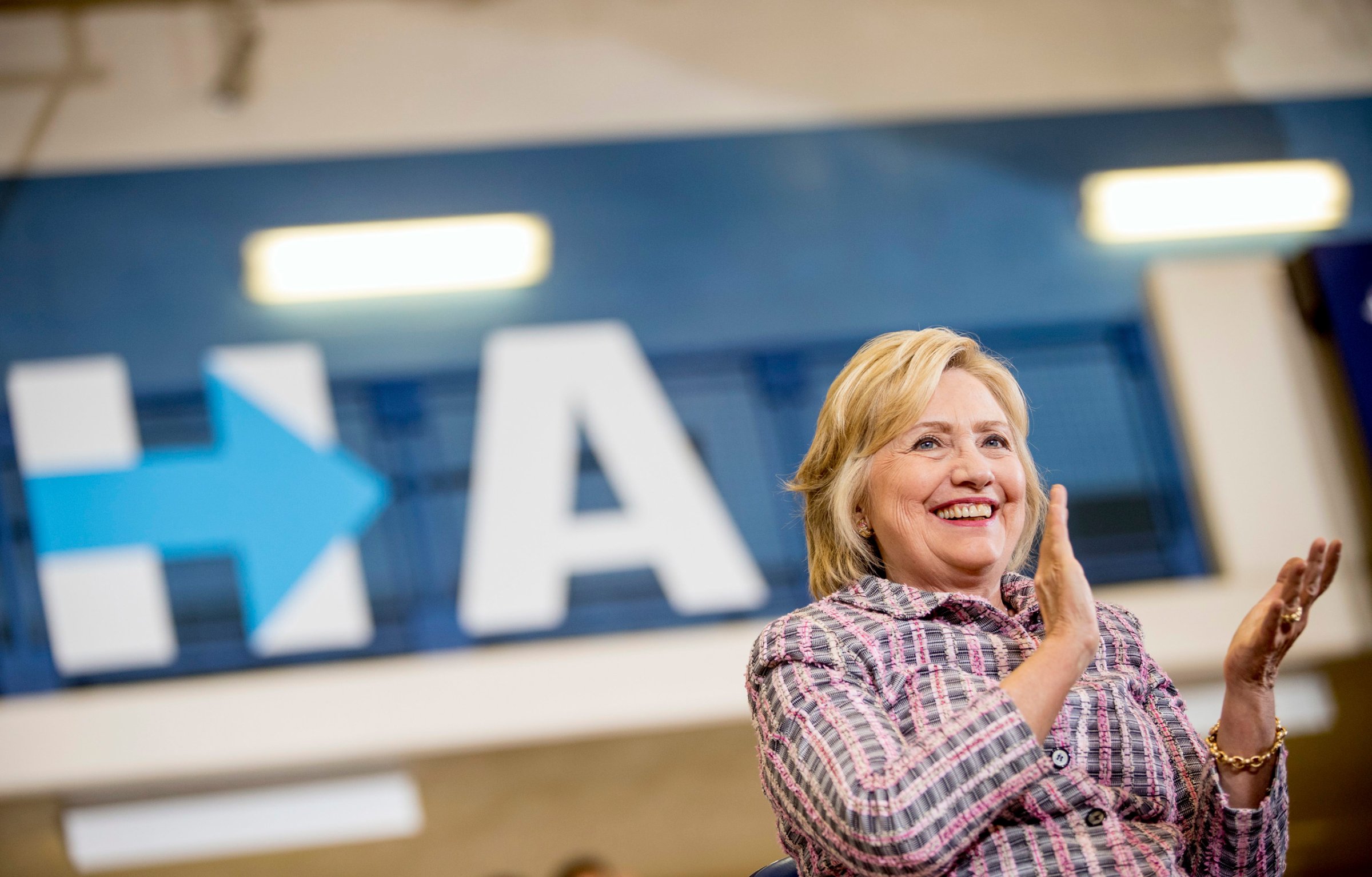 Democratic presidential candidate Hillary Clinton applauds as she sits on stage at a rally at Omaha North High Magnet School in Omaha, Neb. on Aug. 1, 2016.