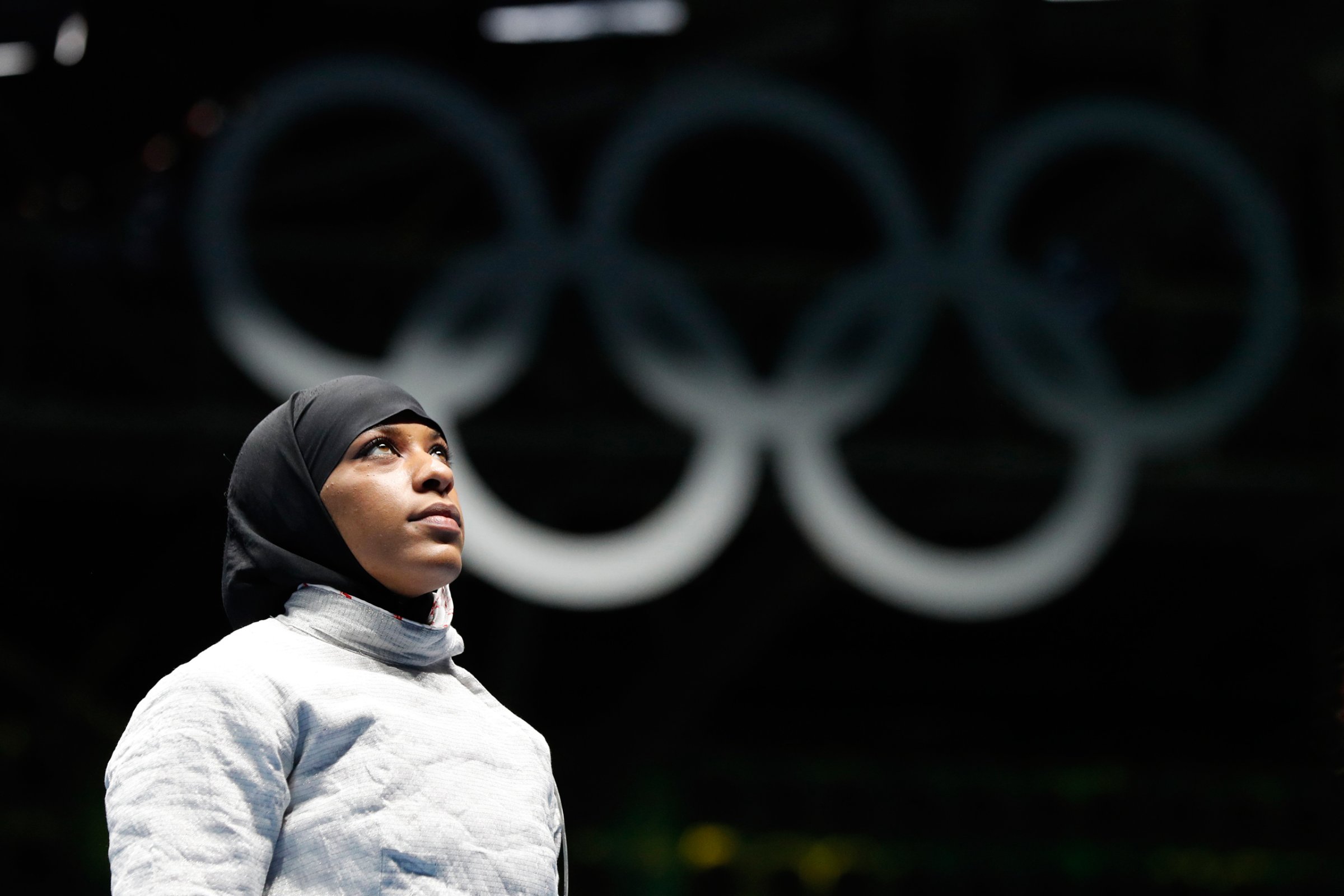 CORRECTS FIRST NAME TO IBTIHAJ FROM UBRIHAJ - Ibtihaj Muhammad, from United States, waits for match against Olena Kravatska from Ukraine, in the women's saber individual fencing event at the 2016 Summer Olympics in Rio de Janeiro, Brazil, Monday, Aug. 8, 2016. (AP Photo/Vincent Thian)
