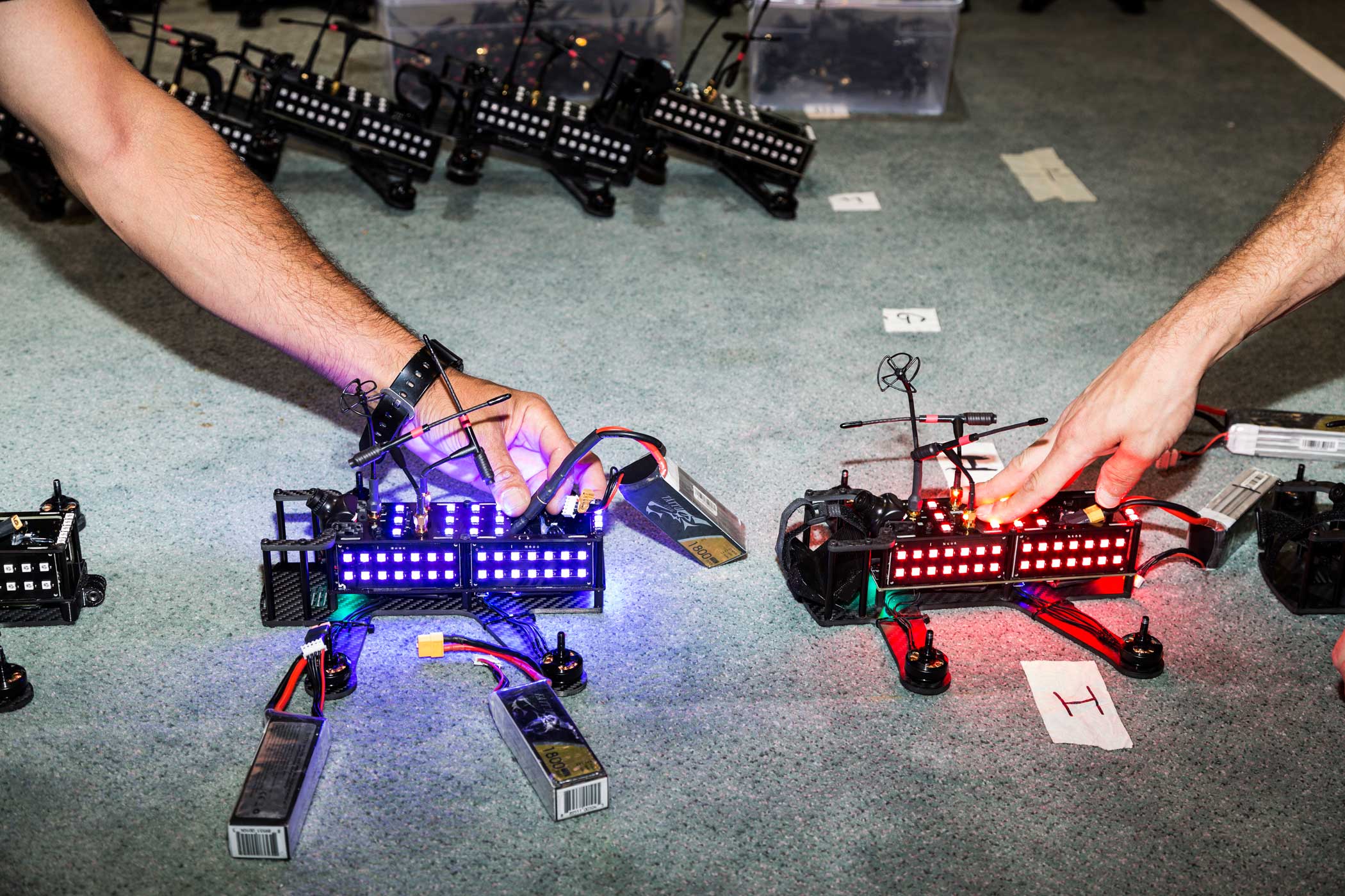The LED lights on two racing drones are tested at the Drone Racing League offices on July 28, 2016 in New York.