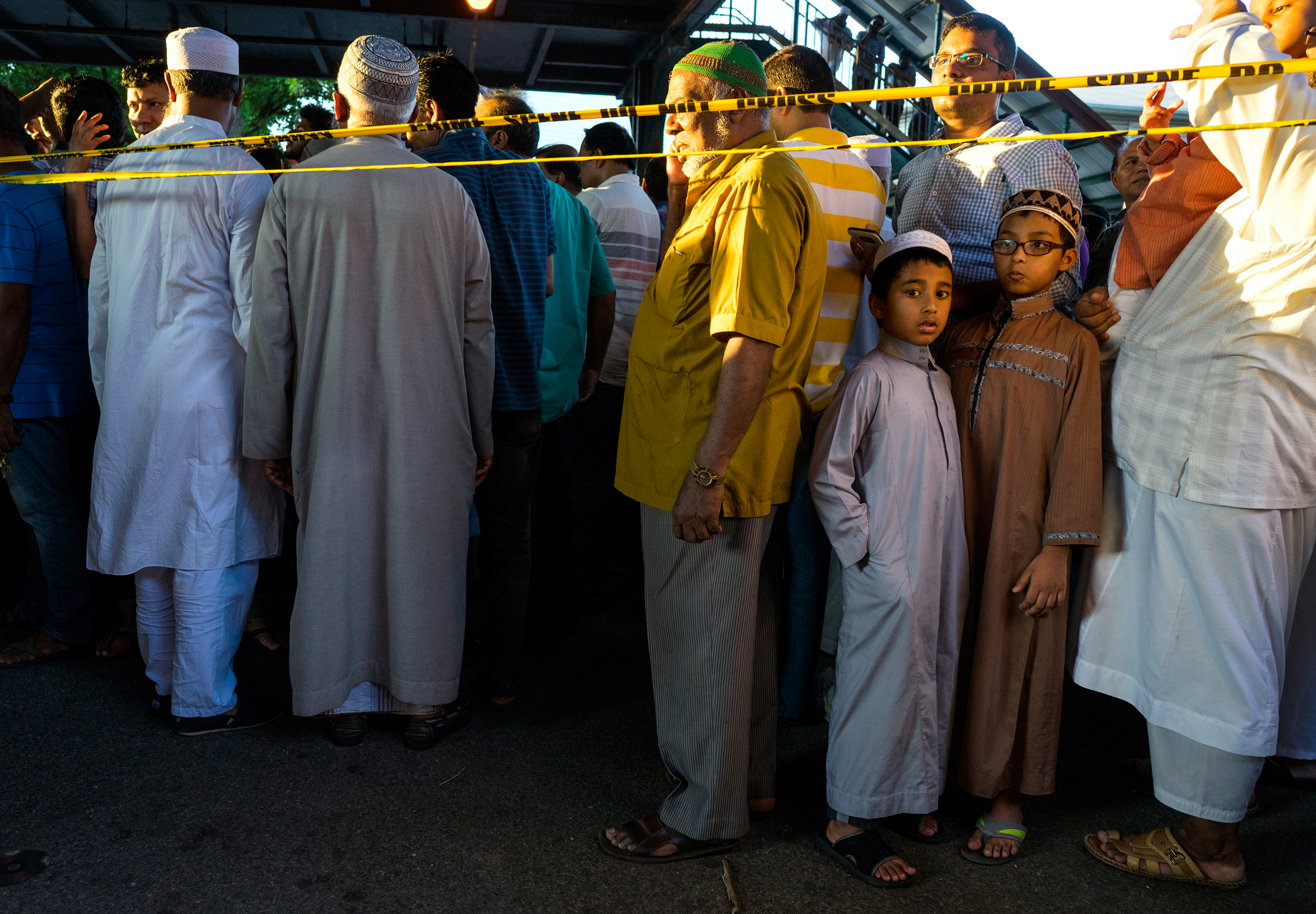 People gather for a demonstration near a crime scene where 55-year-old Imam Maulama Akonjee and his 64-year-old associate, Tharam Uddin, were shot in the back of the head left the Al-Furqan Jame Masjid mosque in the Ozone Park section of Queens in New York City on Aug. 13, 2016, . (Craig Ruttle—AP)