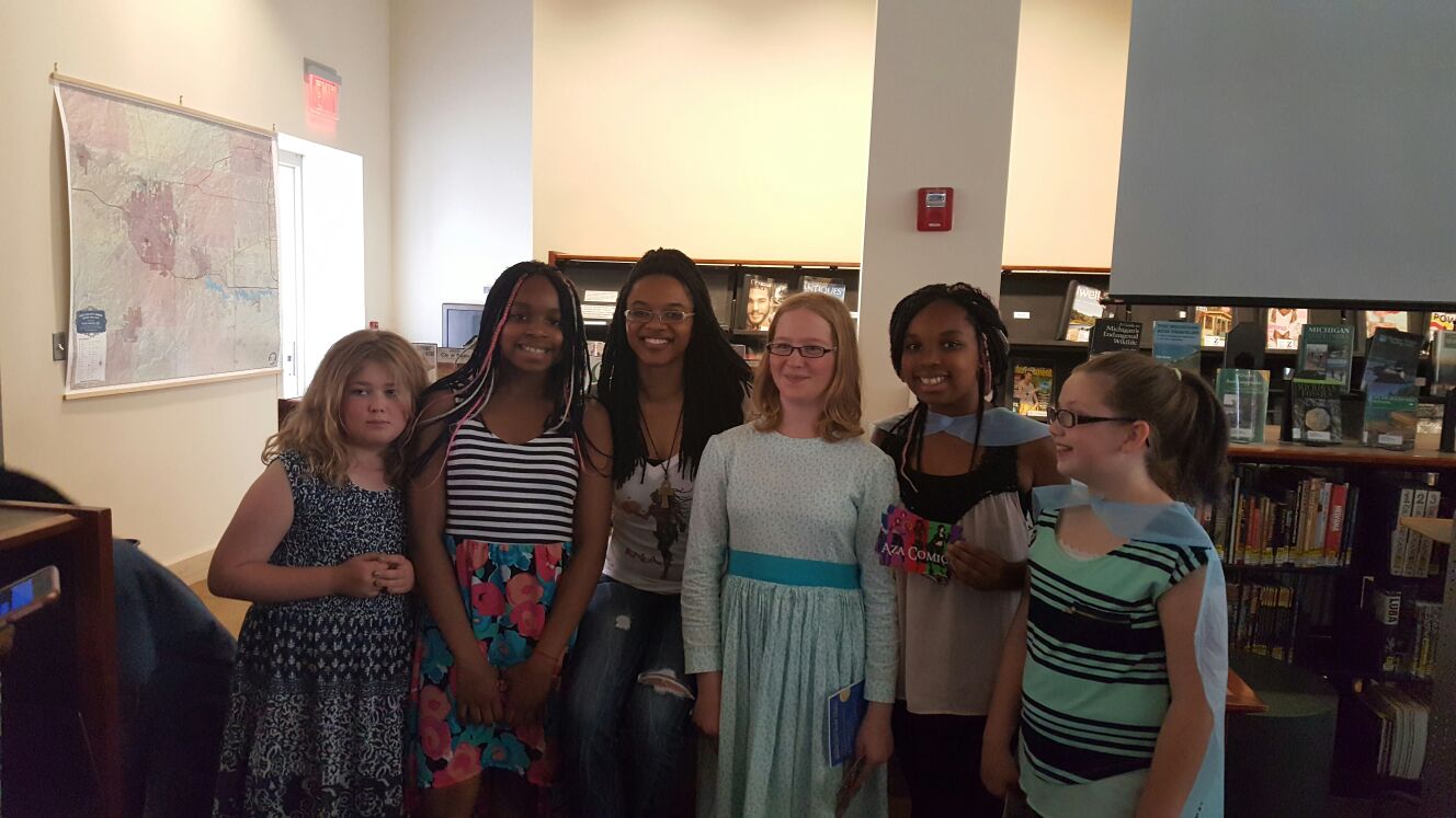 Jazmin Truesdale, founder of Aza Entertainment, poses with girls at the June 2016 Ann Arbor Book Festival. (Photo courtesy of Jazmin Truesdale)