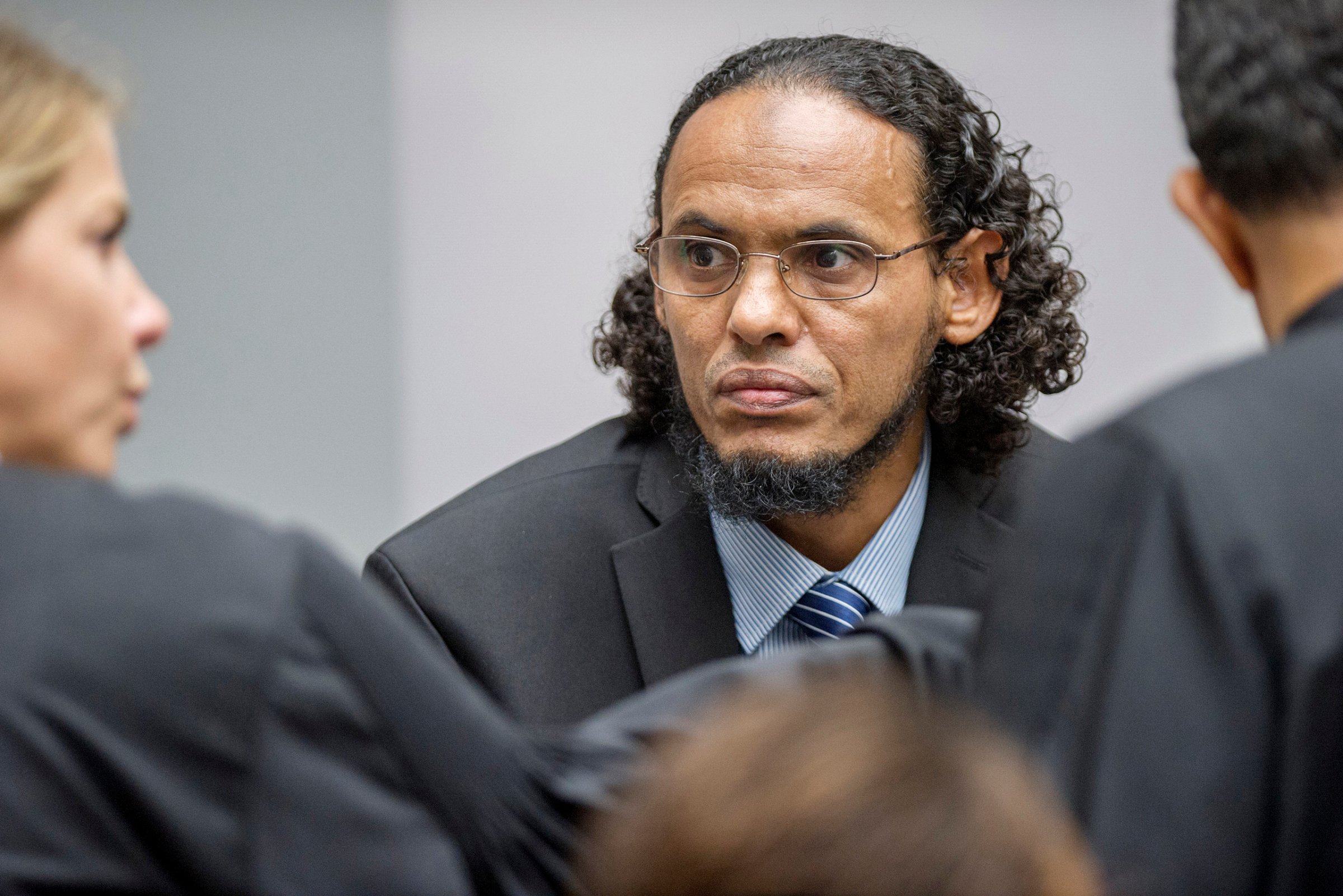 Ahmad Al Faqi Al Mahdi, center, appears at the International Criminal Court in The Hague, Netherlands, on Aug. 22, 2016, at the start of his trial on charges of involvement in the destruction of historic mausoleums in the Malian desert city of Timbuktu.