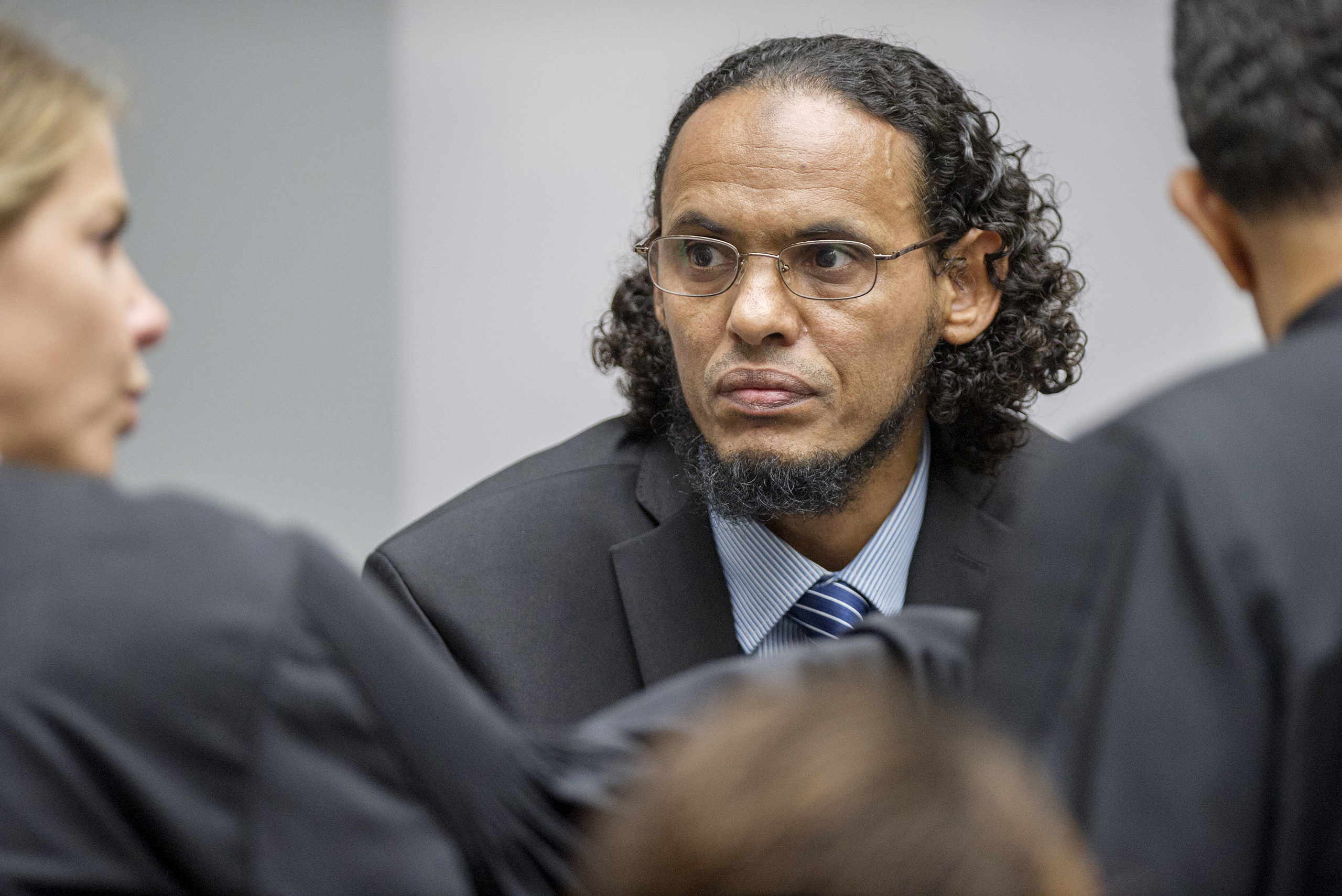 Ahmad Al Faqi Al Mahdi, center, appears at the International Criminal Court in The Hague, Netherlands, on Aug. 22, 2016, at the start of his trial on charges of involvement in the destruction of historic mausoleums in the Malian desert city of Timbuktu. (Patrick Post—AP)