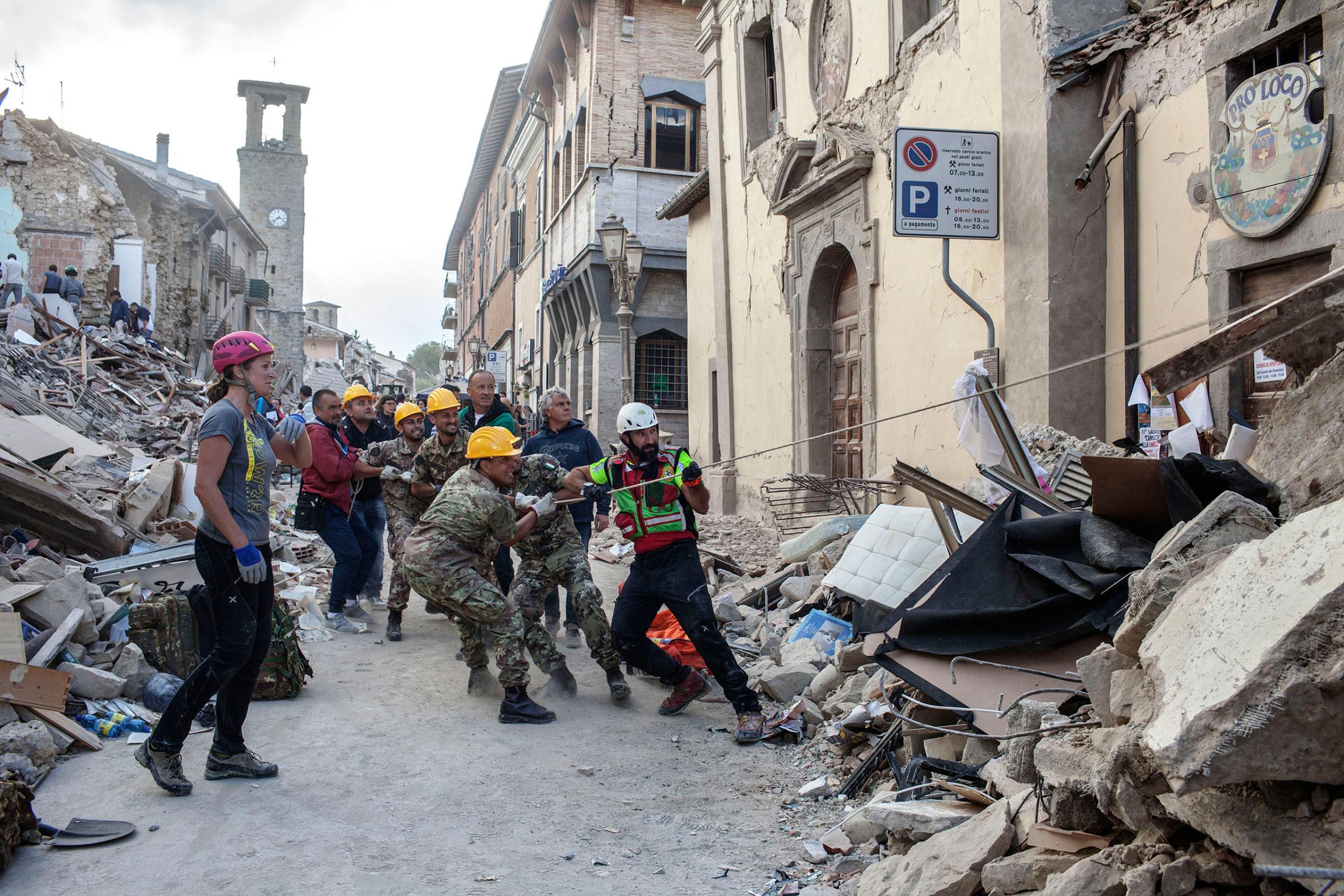 Rescue teams attempt to move the rubble in search of survivors after a 6.2 earthquake hit the town of Amatrice, Italy, on Aug. 24, 2016.