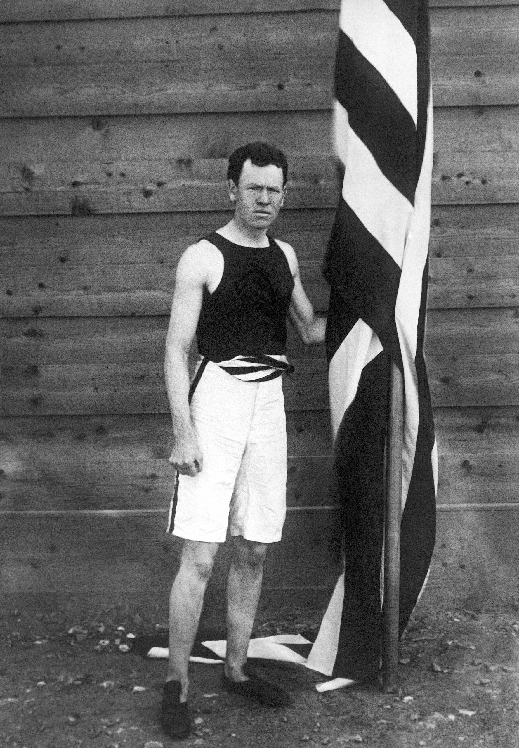 James Brendan Bennet Connolly from South Boston, USA, poses with a flag at the first modern International Summer Olympic Games held at the Panathinaiko Stadium on April 6, 1896 in Athens, where he won the gold medal in triple jump with 13.71 meters.