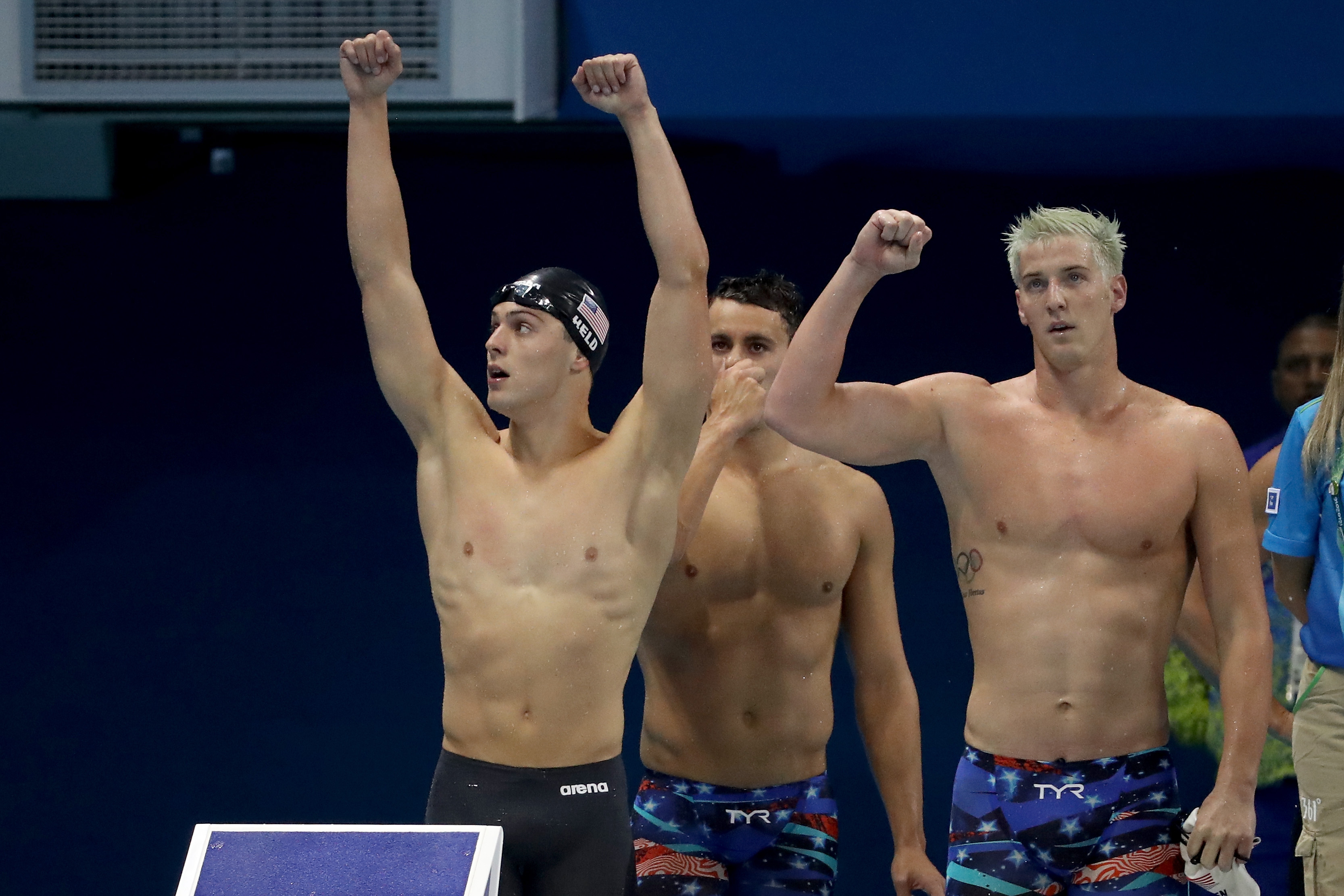 American Olympic swimmer James Feigen (at right) celebrates a relay race win on Day 2 of the Rio 2016 Olympic Games at the Olympic Aquatics Stadium on August 7, 2016 in Rio de Janeiro, Brazil.  (Photo by Al Bello/Getty Images)