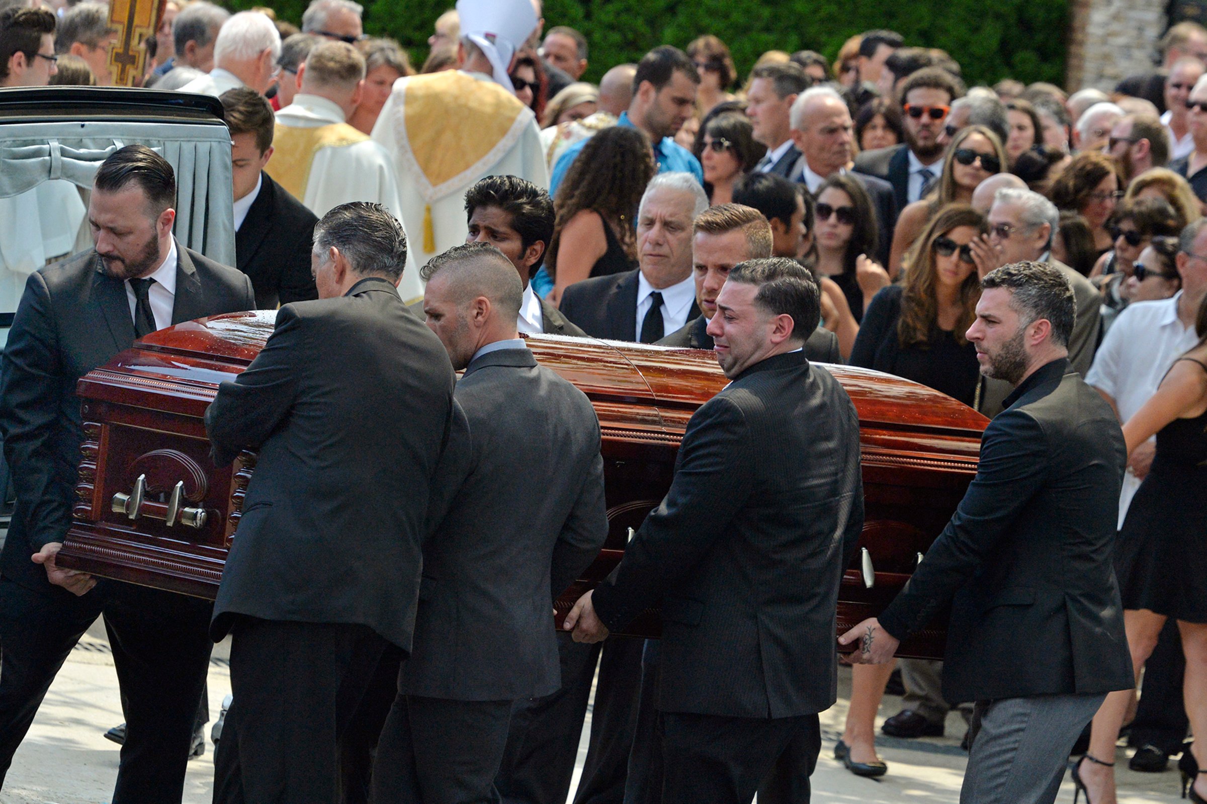 Mourners carry the casket of Karina Vetrano from St. Helen's Church following her funeral in Queens, New York on Aug. 6, 2016. Vetrano was killed while running alone during daylight hours through a Queens park the previous week.