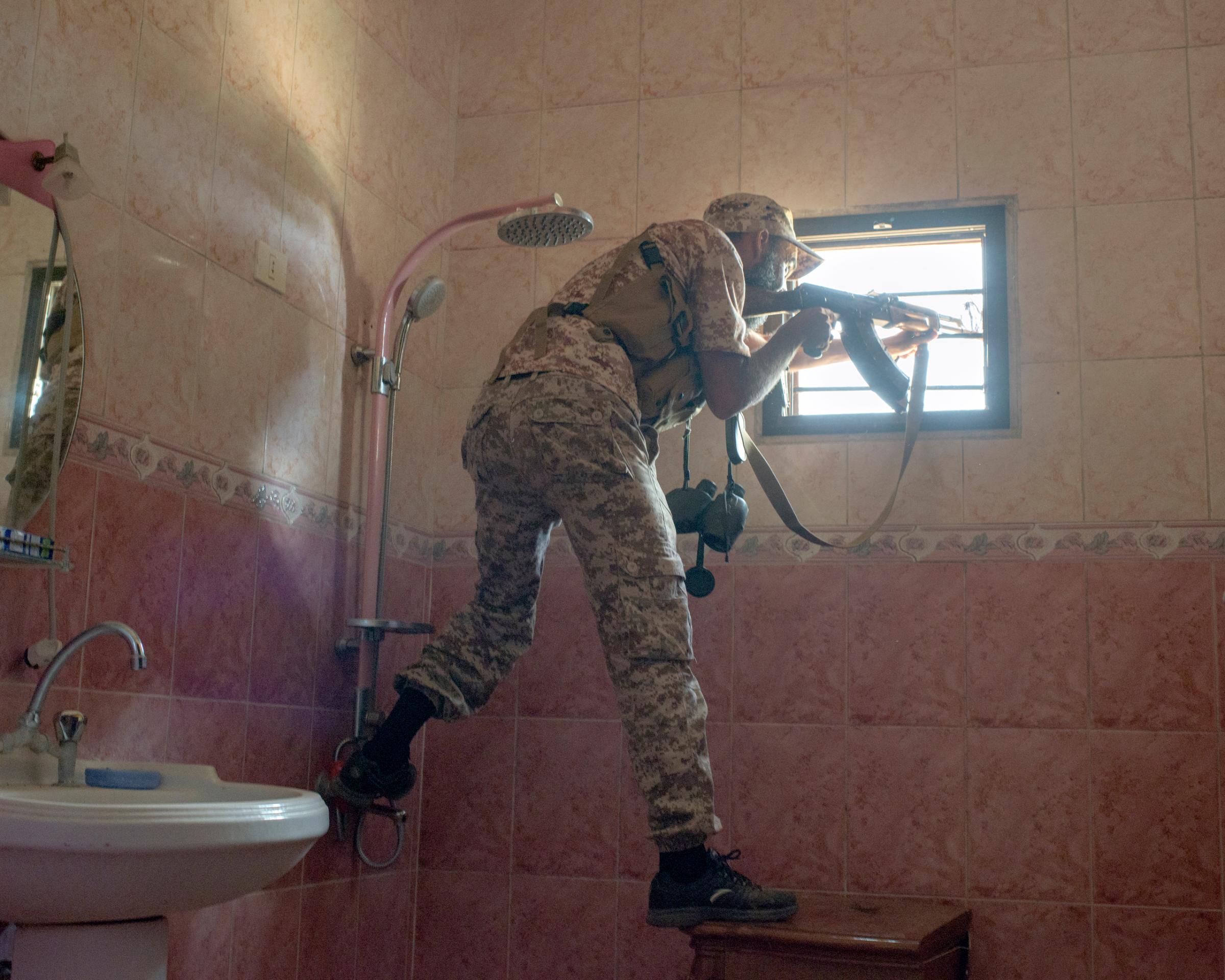 A Libyan sniper in Sirt’s Hay Dollar district, Libya, July 2016.