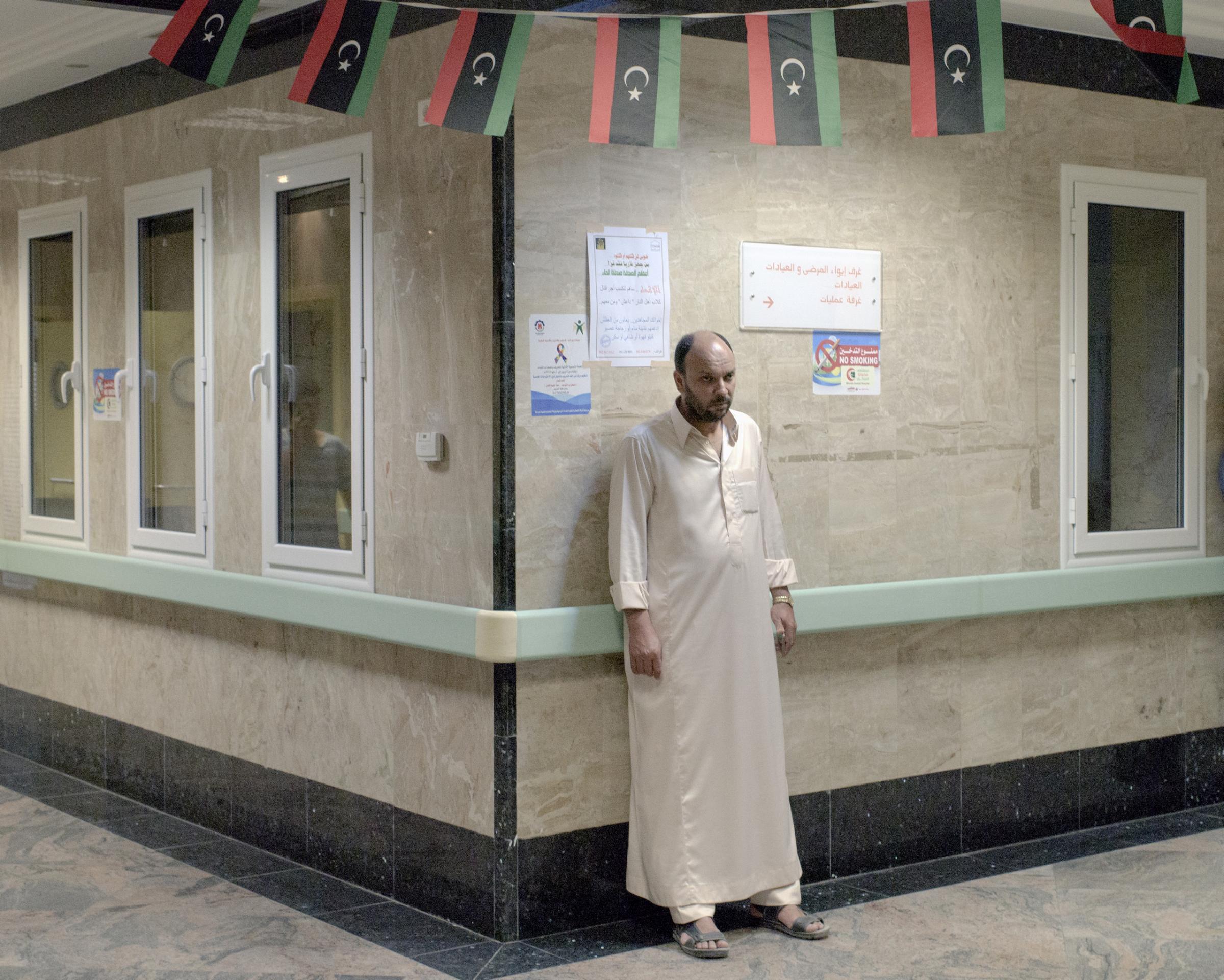 A relative of a wounded fighter waits outside the emergency room of Misurata Central Hospital Sirt, Libya, July 2016.