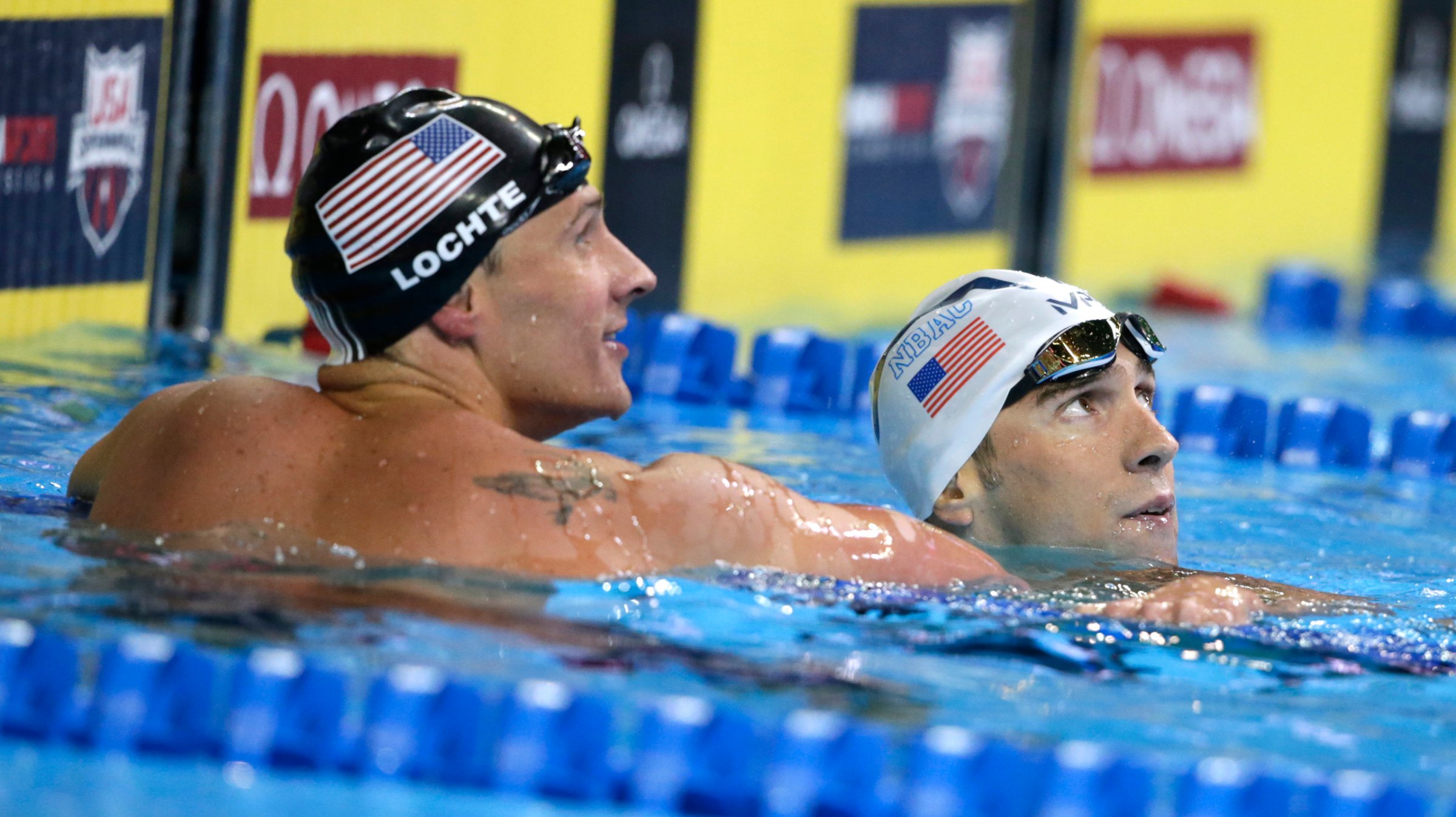 Michael Phelps, right, reacts with Ryan Lochte, left, after winning the men's 200-meter individual medley final at the U.S. Olympic swimming trials, in Omaha, Neb. on July 1, 2016. Lochte finished in second place.
