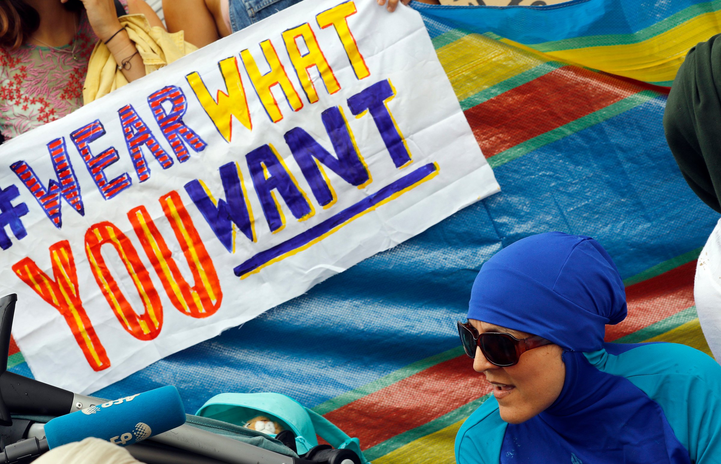 An activist protests outside the French embassy during, the "wear what you want beach party" in London, on Aug. 25, 2016.