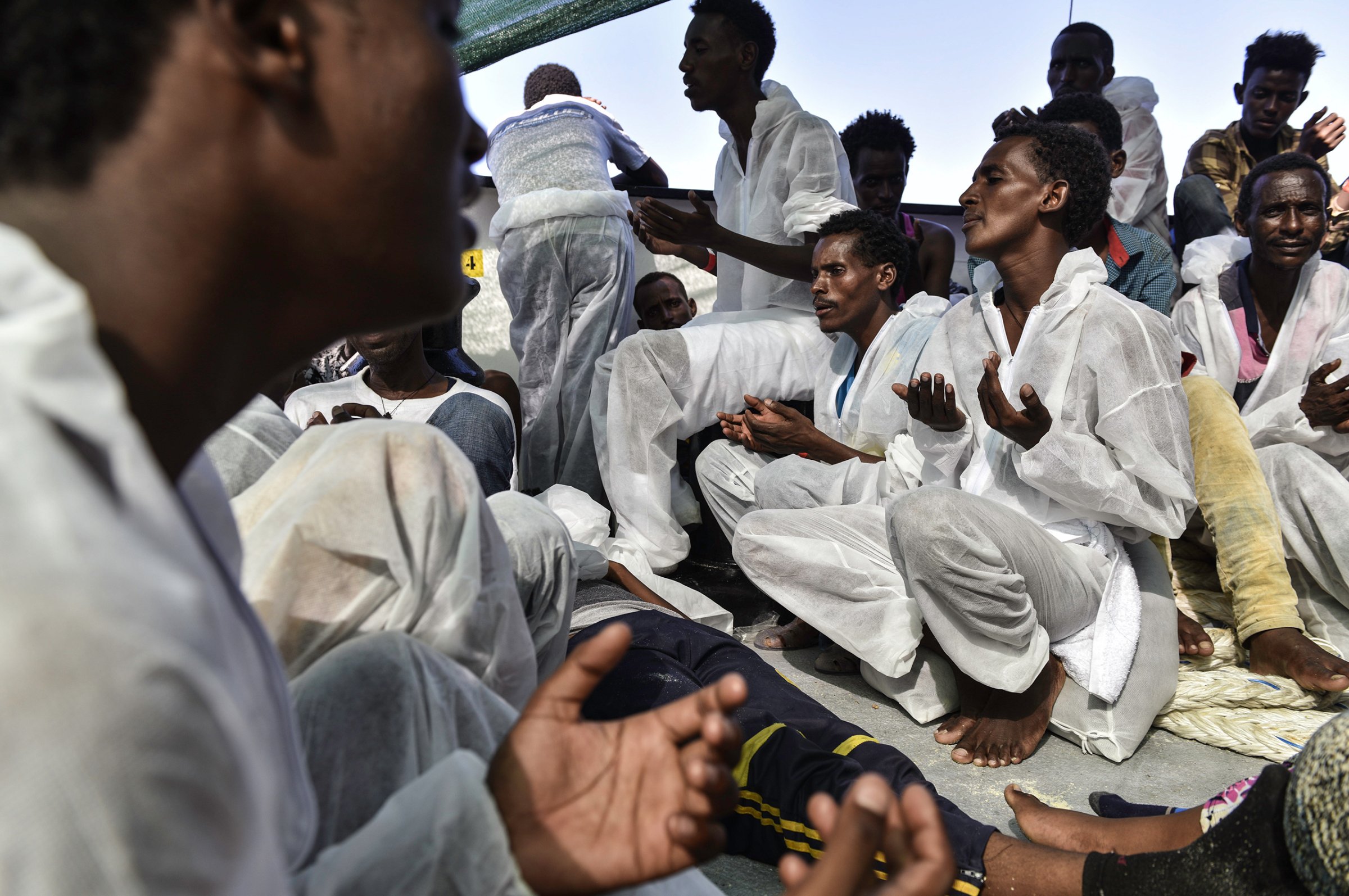 Eritrean Orthodox Christian men sing and pray after their rescue, Aug. 21, 2016.