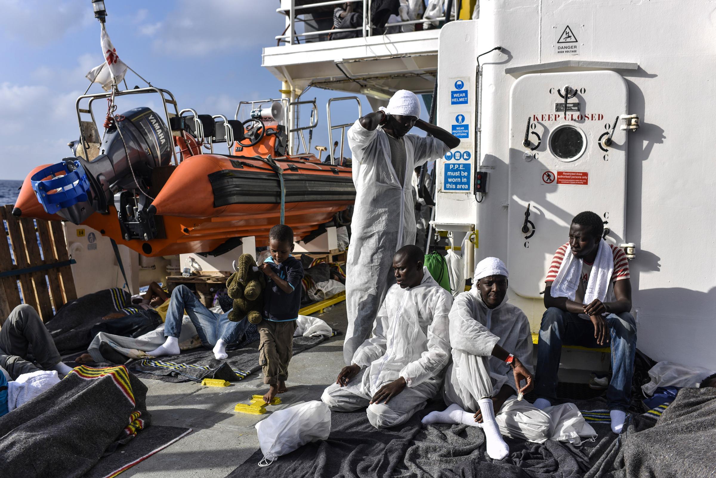 Muslim migrants preparing for prayer on the deck of the MV Aquarius ship, Aug. 22, 2016.