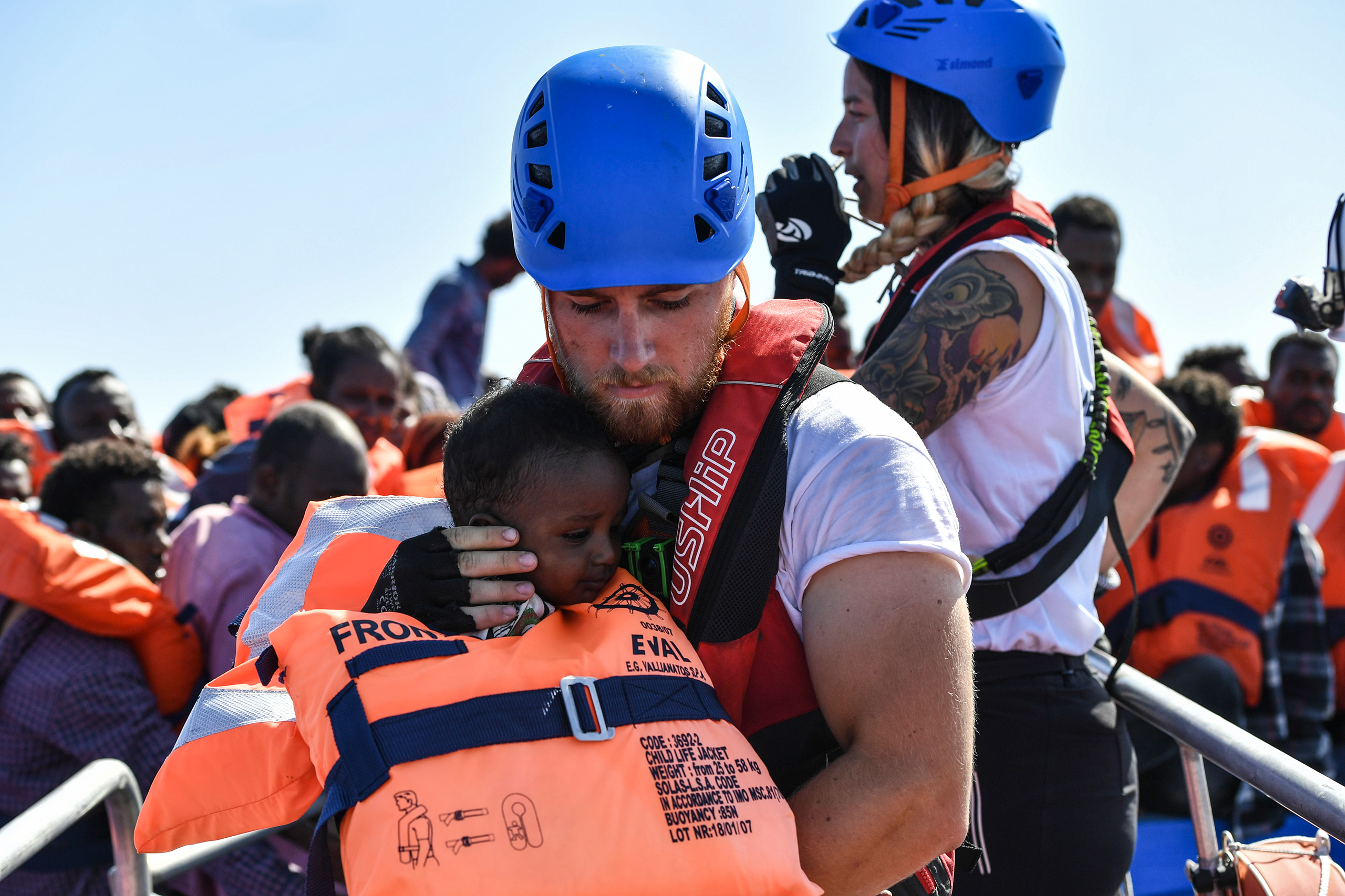A rescue worker cradles a young child to safety, Aug. 21, 2016.