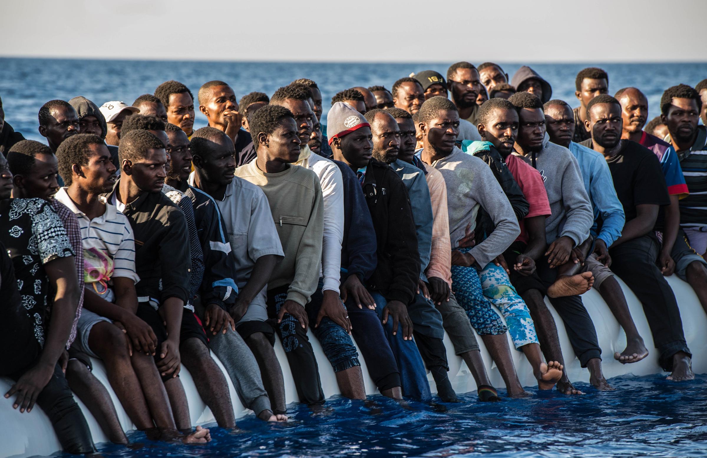 Migrants on the rubber boat in Mediterranean are rescued, Aug. 20, 2016.