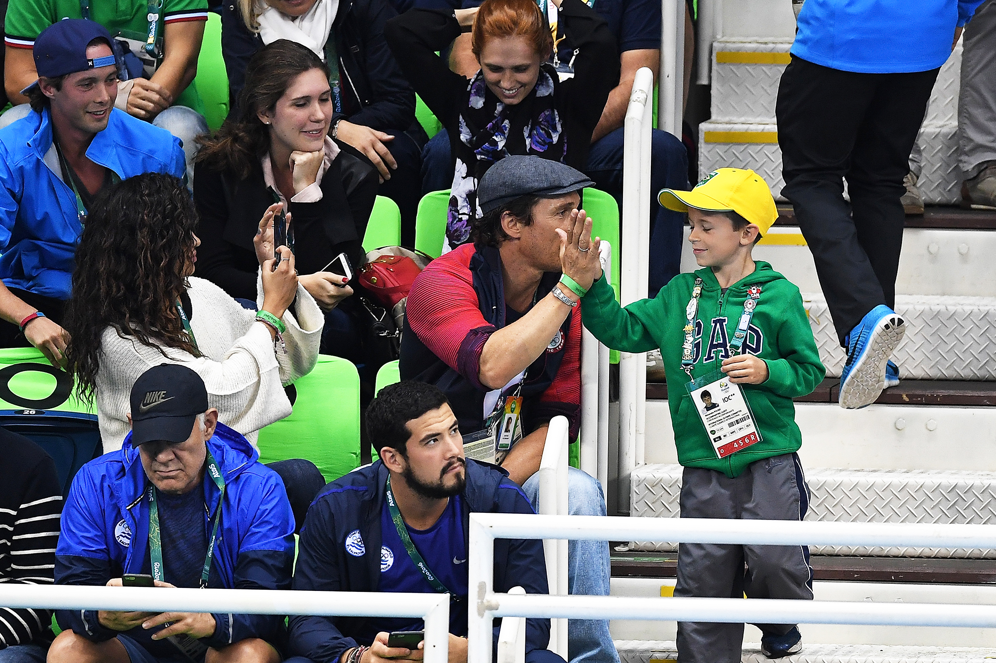 Matthew McConaughey gives a high five to a young boy during the swimming semifinals and finals on Day 5 of the Rio 2016 Olympic Games, on Aug. 9, 2016 in Rio de Janeiro, Brazil.