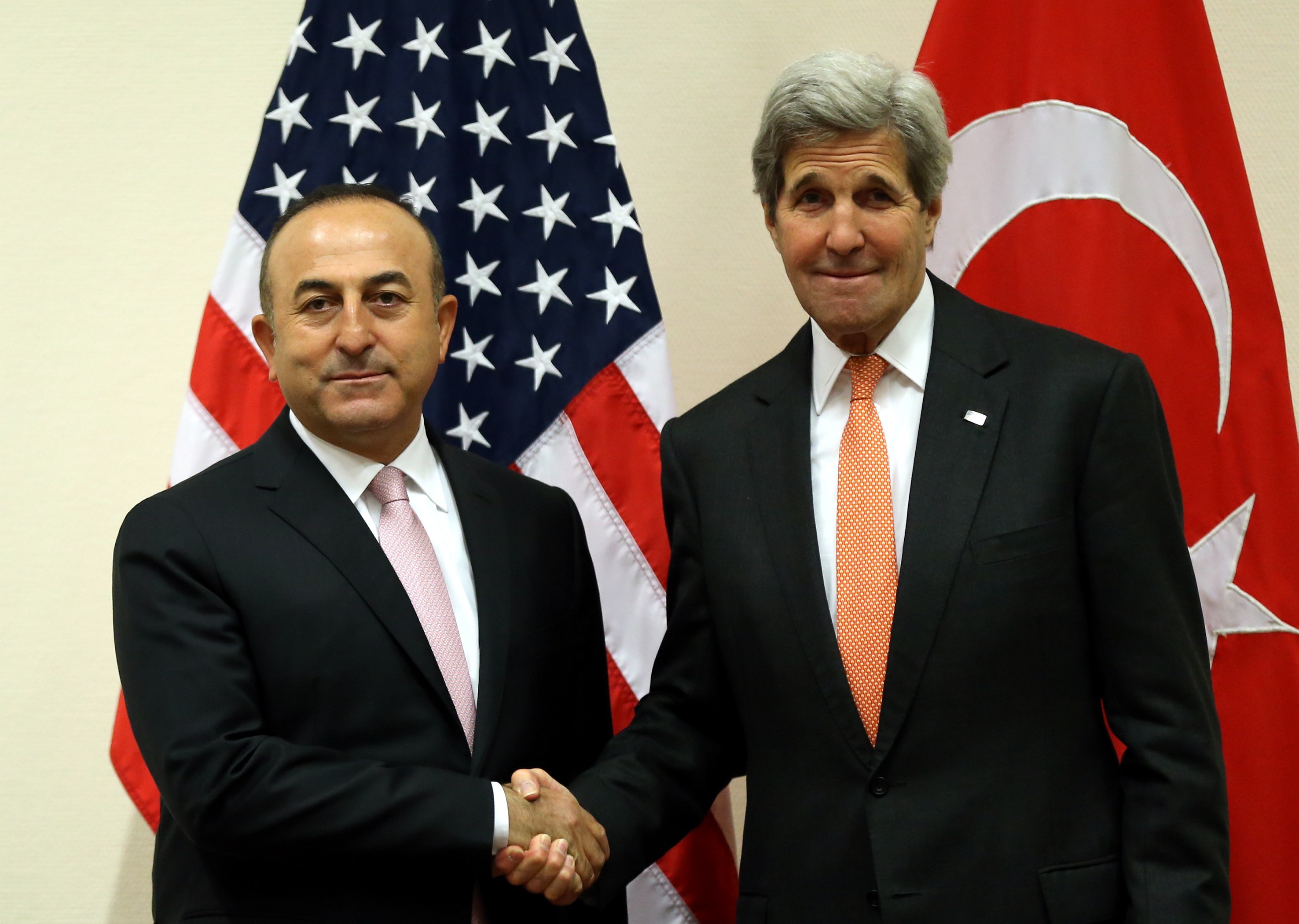 Turkish Foreign Affairs Minister Mevlut Cavusoglu (left) and US Secretary of State John Kerry (right) shake hands during the NATO Foreign ministers meeting at the NATO headquarters in Brussels, Belgium on May 20, 2016. (Anadolu Agency—Getty Images)