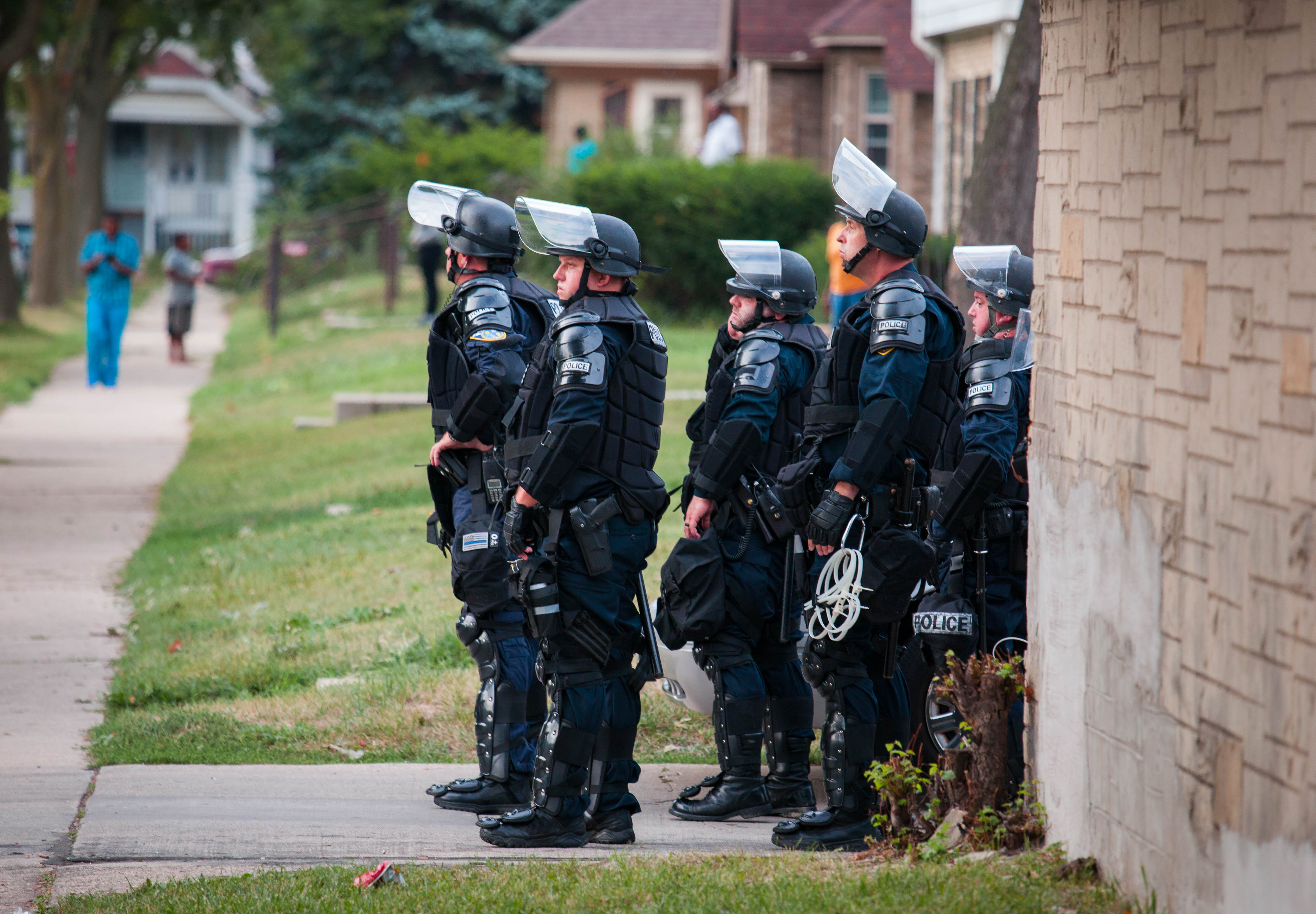 Police in riot gear wait in an alley after a second night of clashes between protestors and police in Milwaukee, Wisc., on Aug. 15, 2016. (Darren Hauck—Getty Images)