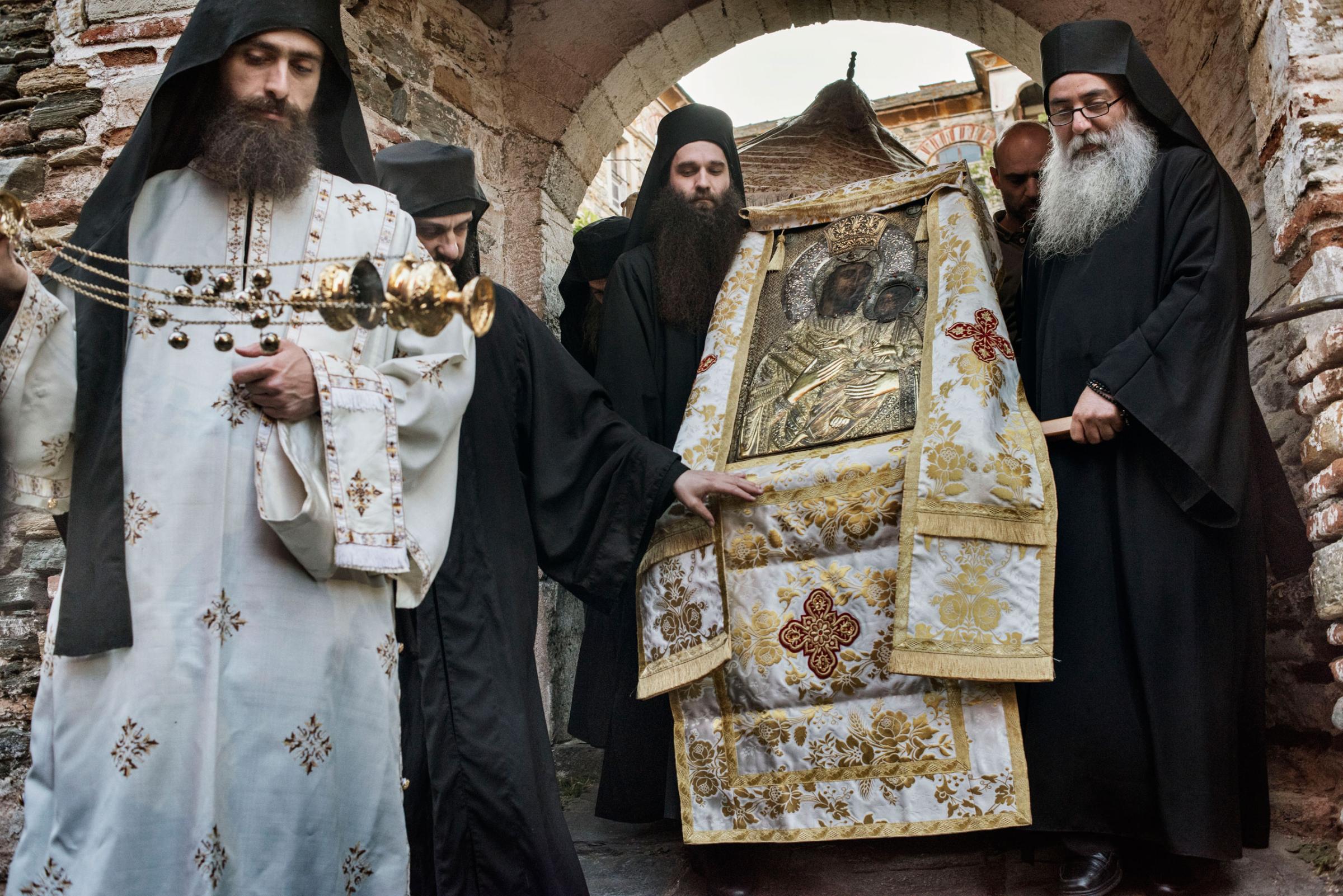 Mount Athos, Greece May 28, 2016. Monks and laymen stand outside the Protaton, the oldest church on Mount Athos, a self-governing monastic community in northern Greece, May 28, 2016.